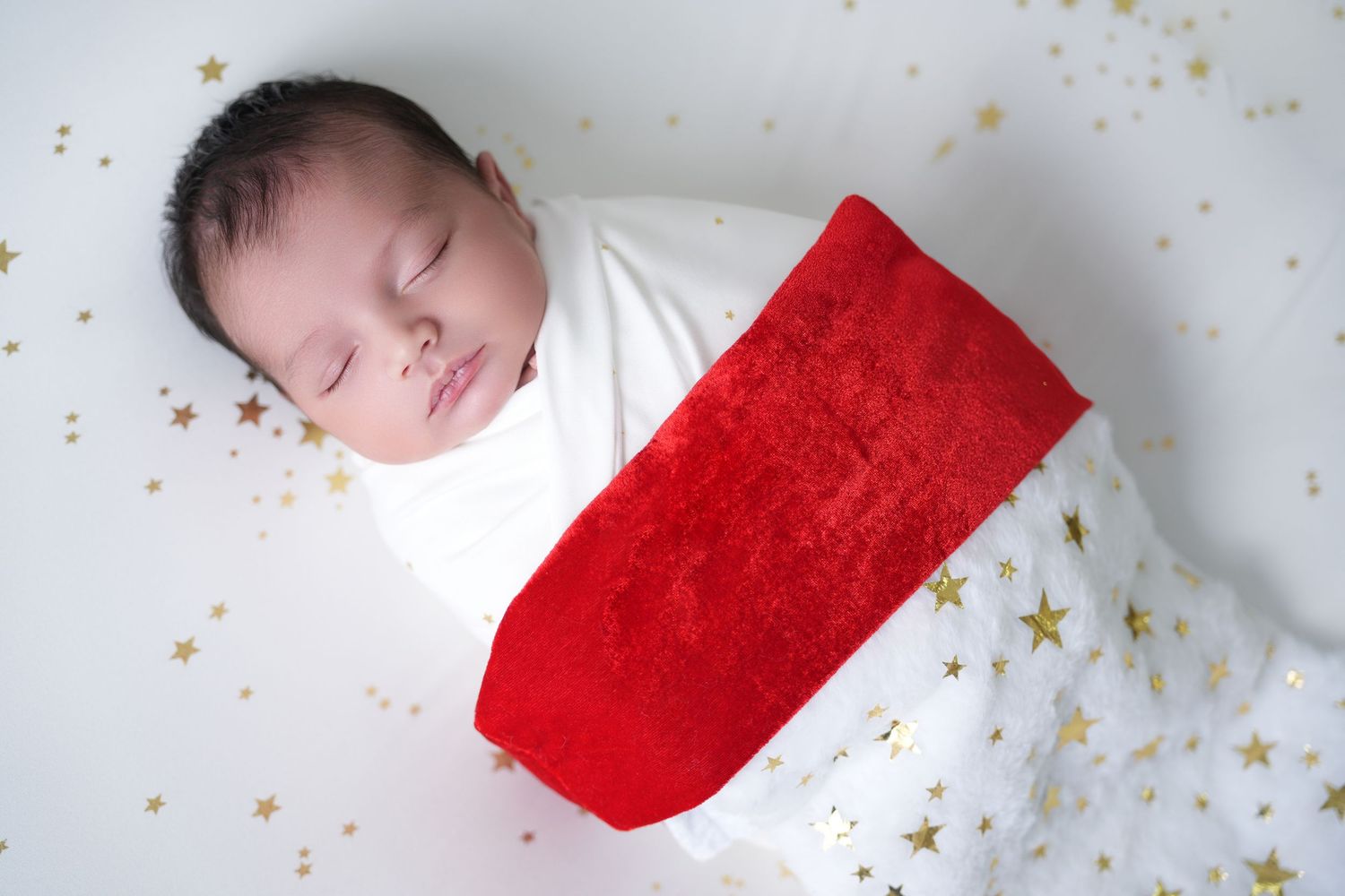 Newborn photographer in Dubai capturing a baby in a cozy, safe studio setup.