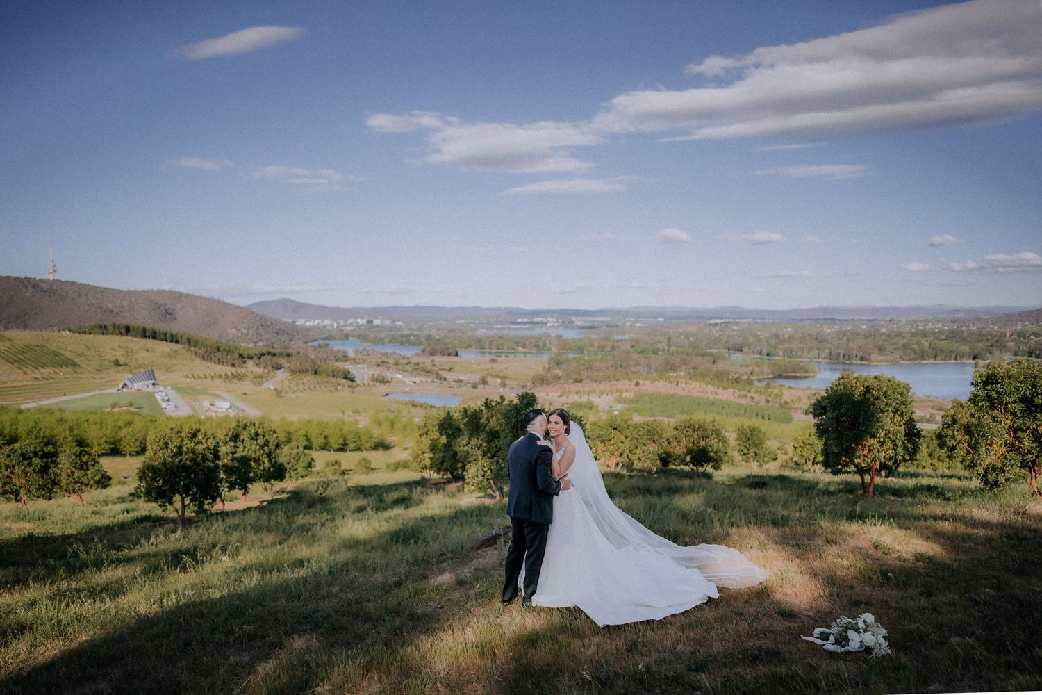 Wedding exit celebration with guests creating sparkler tunnel for dancing couple.