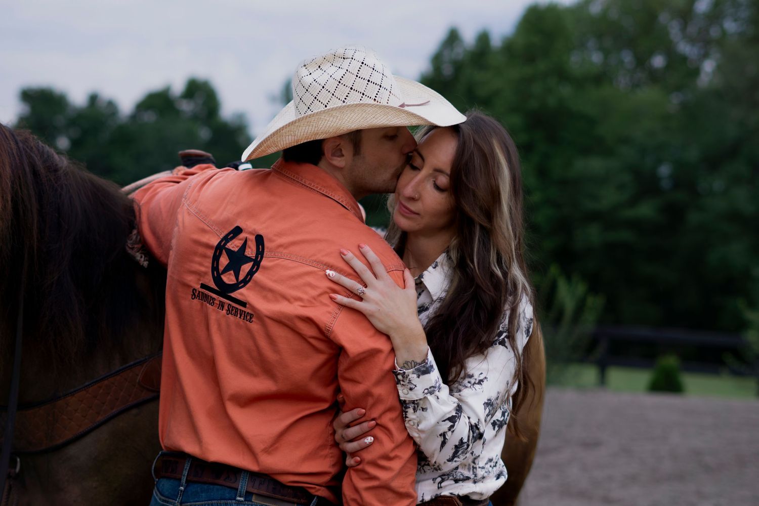couple in western hat and embrace
