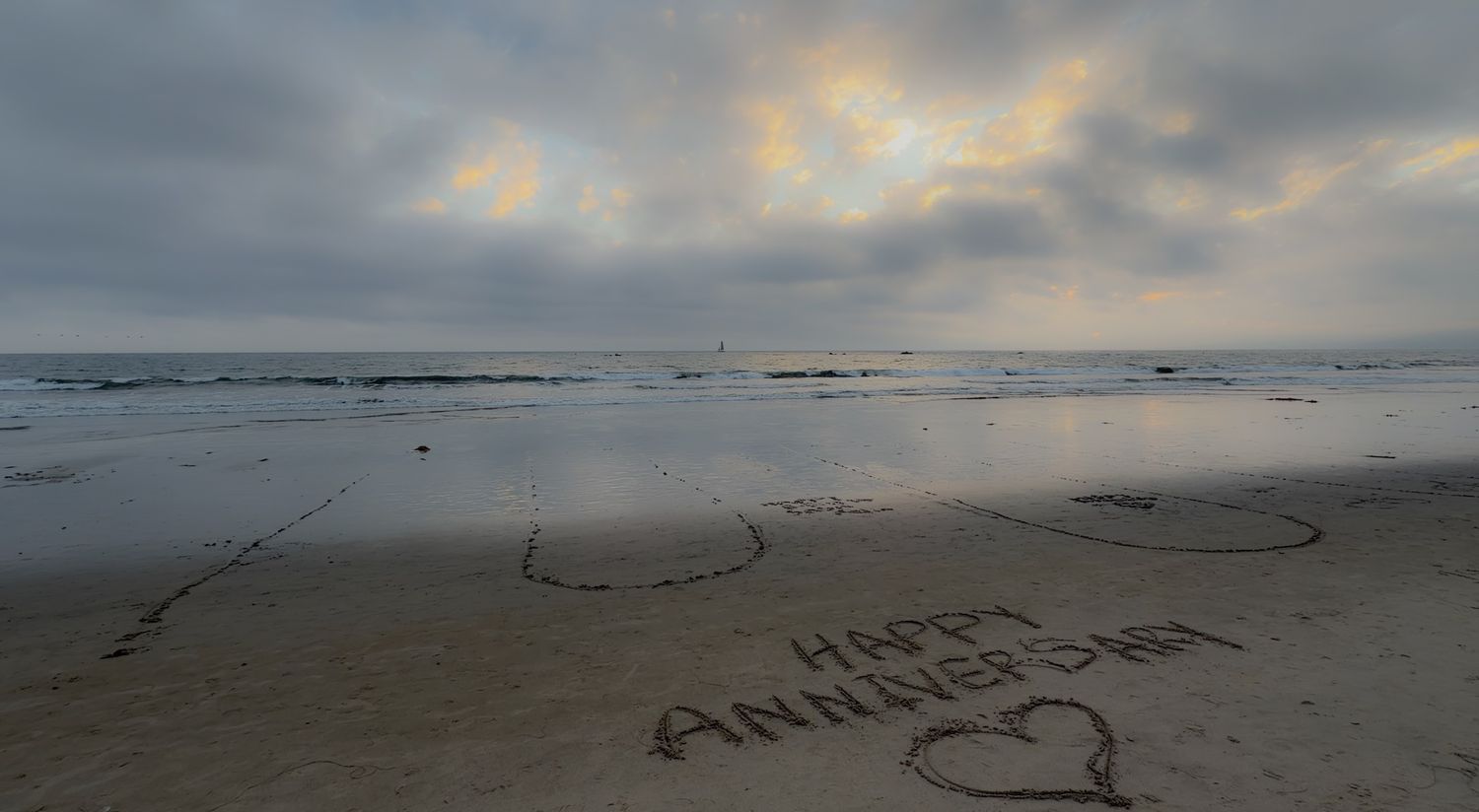 A panoramic sequence of ocean beach views at sunset with clouds and messages written in sand.