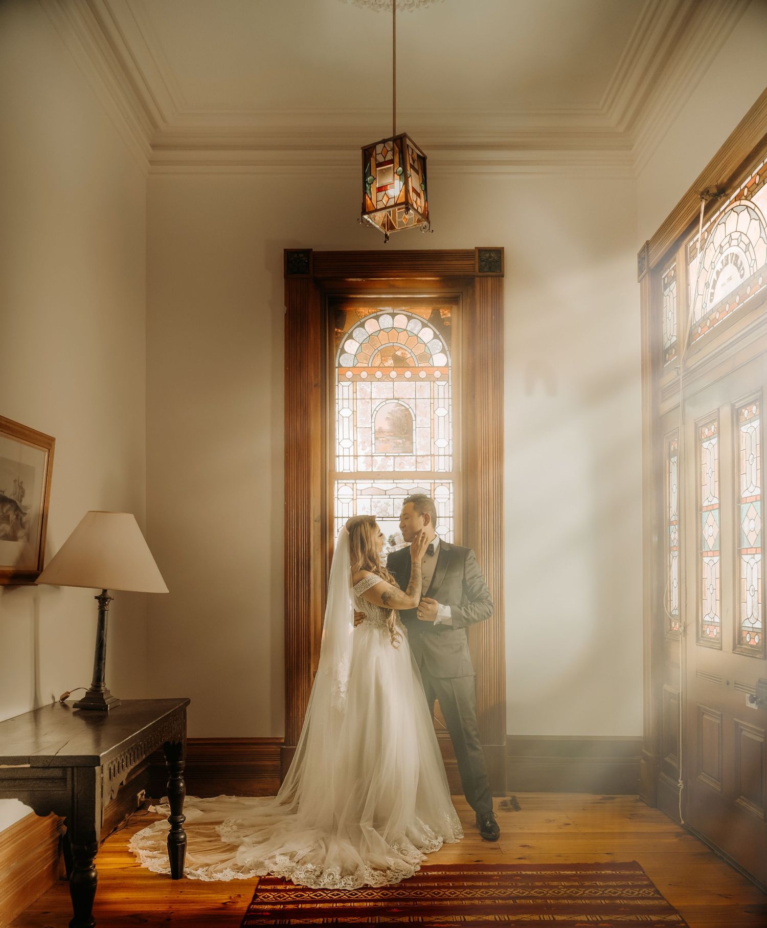 A series of wedding photos showing a couple in formal attire standing by sunlit windows in an elegant indoor setting.