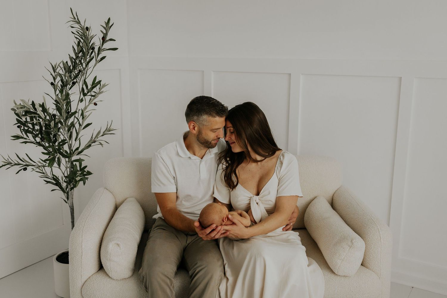 Lakeville MN studio newborn photography – sleeping newborn baby held by mom & dad