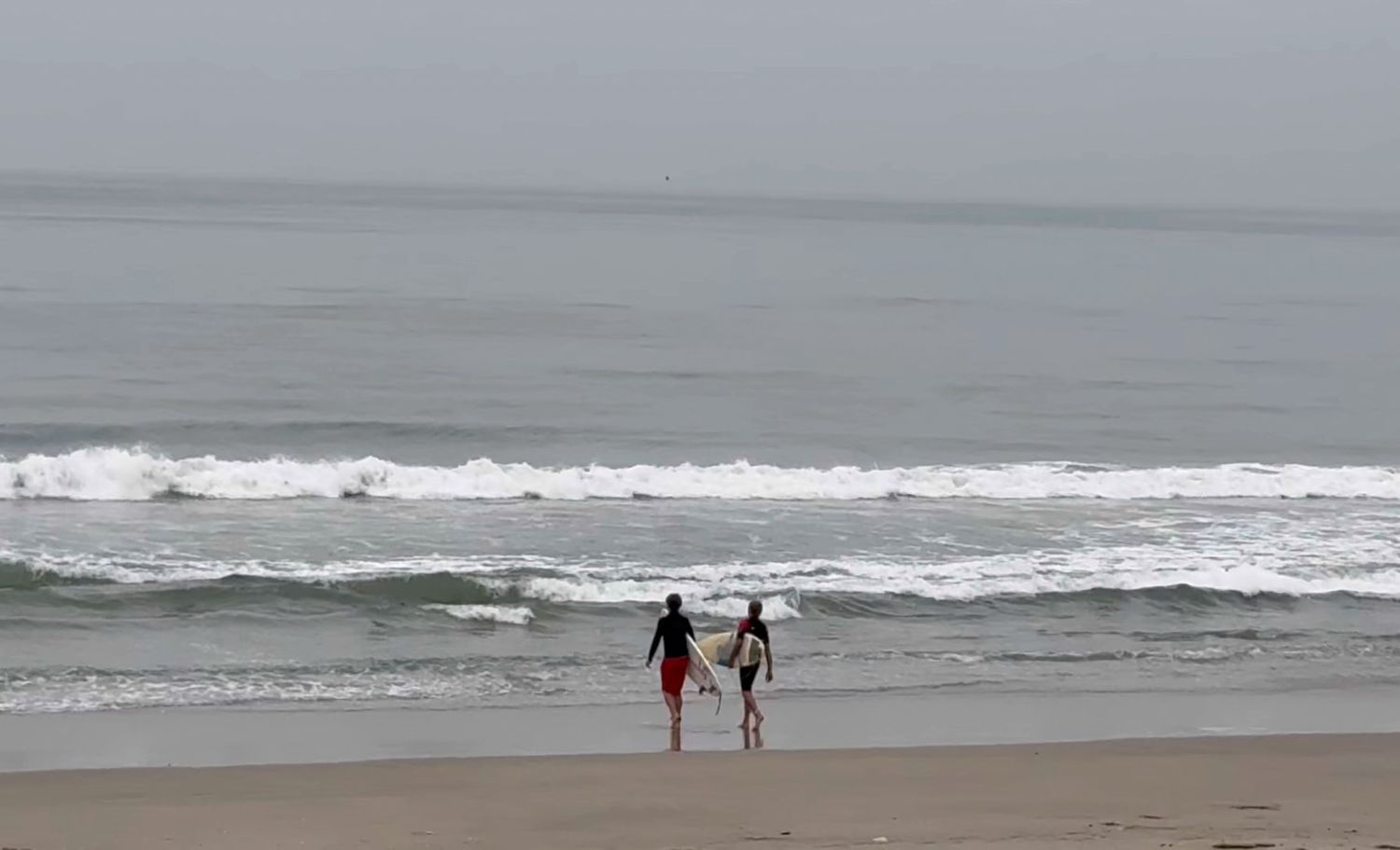 Seven connected ocean beach scenes show waves crashing on a cloudy day with a few people walking along the shoreline.