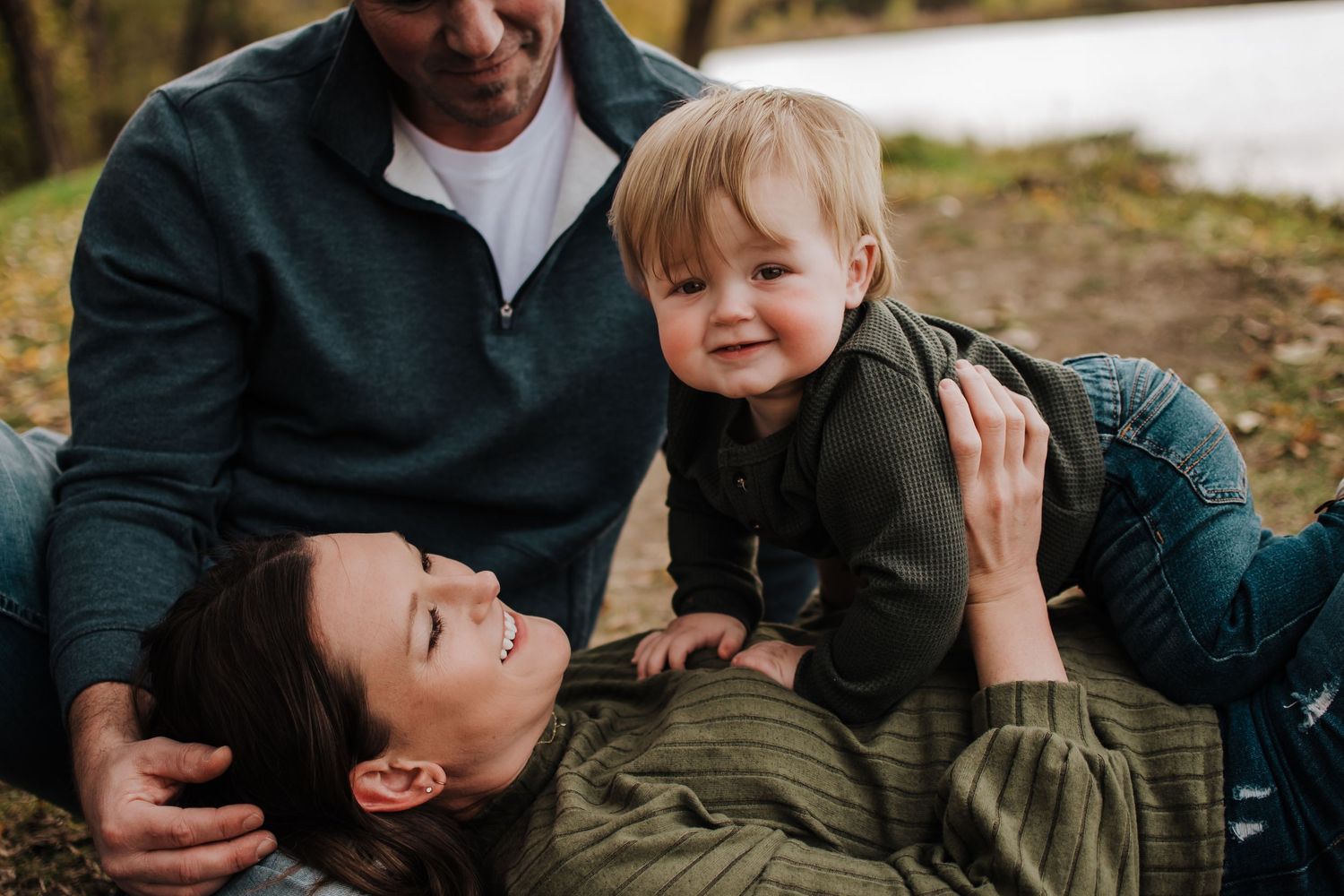 A playful outdoor family moment captured during an autumn day.