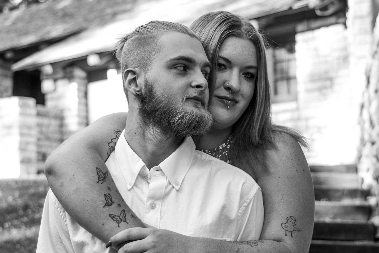 A romantic black and white portrait of a couple embracing on their special day.
