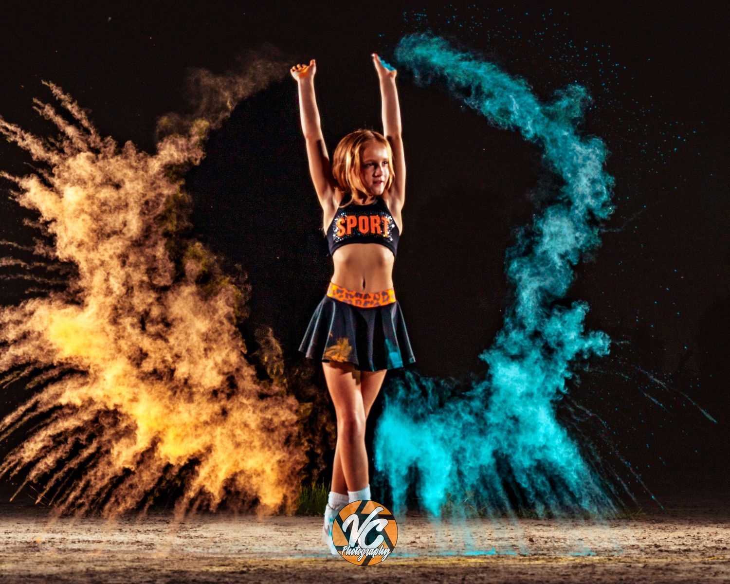 A female athlete in a skirt kicks a soccer ball surrounded by vibrant pink and yellow color powder explosions.