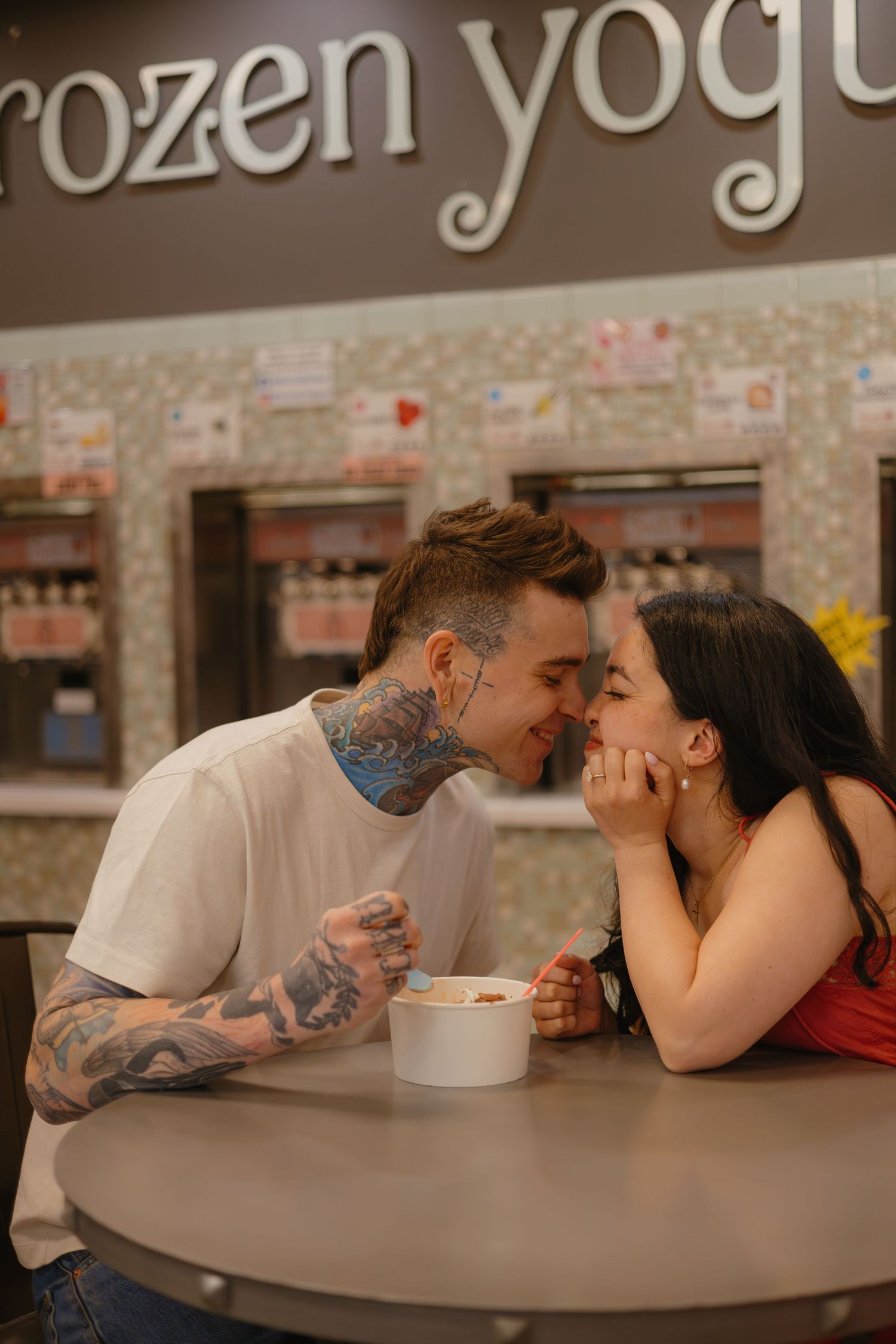 Couple sharing frozen yogurt during their downtown Parker engagement session.
