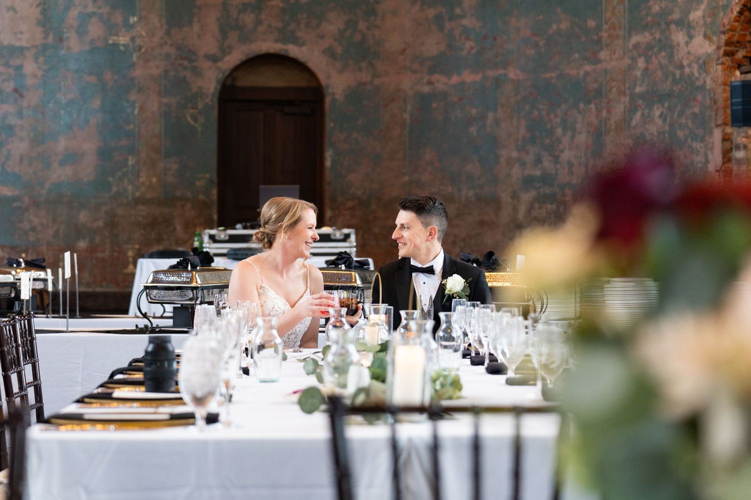 Bride and groom share a joyful moment captured by a Cincinnati wedding photographer at The Monastery Cincinnati Event Center.