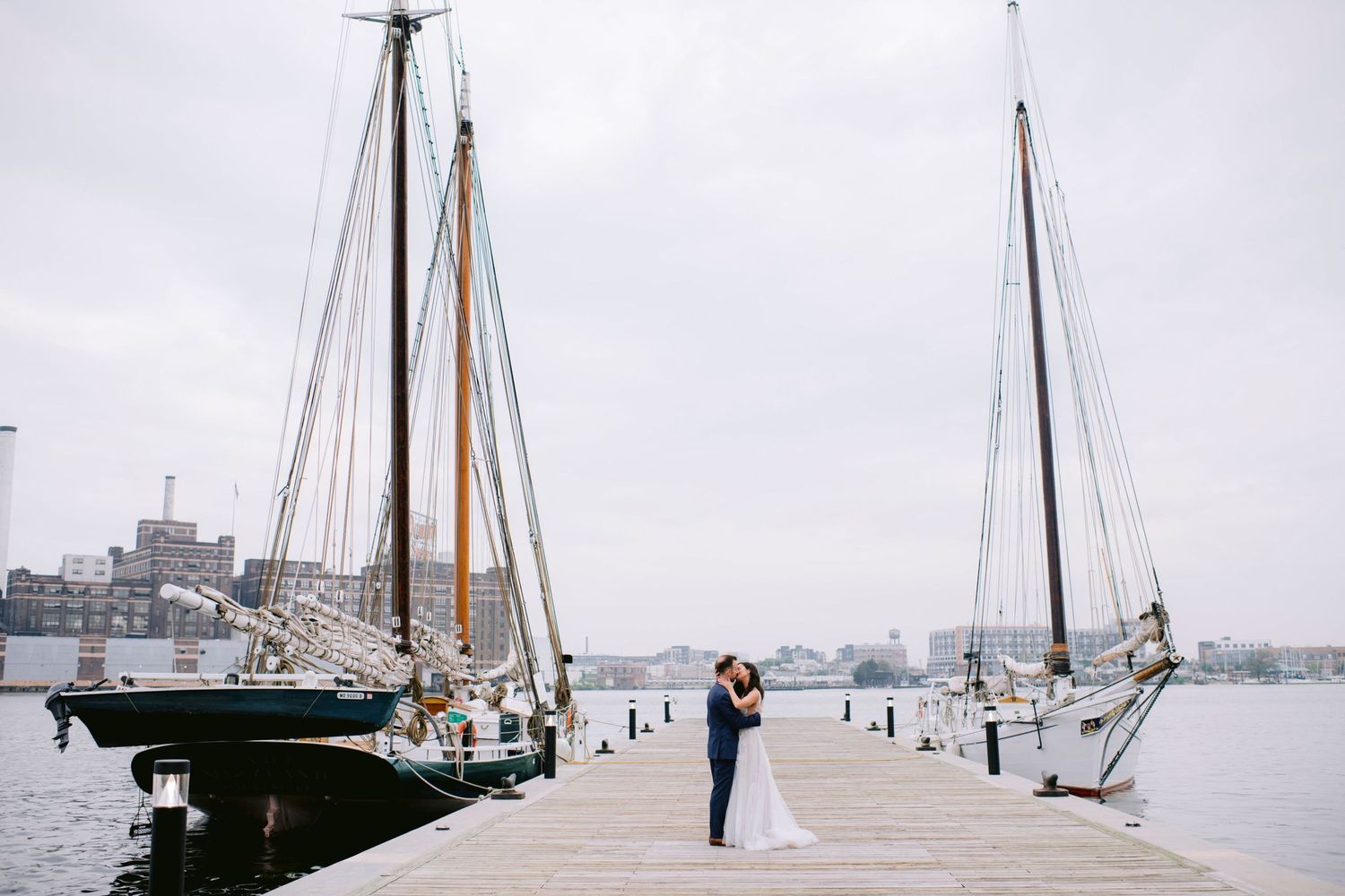 Just married couple embracing at elegant wedding venue with period artwork and windows at the DAR Constitution Hall in Washington DC.
