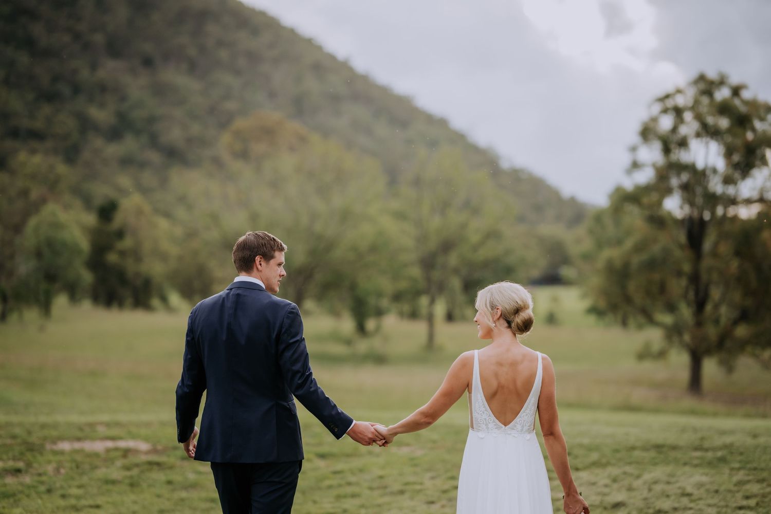 Wedding exit celebration with guests creating sparkler tunnel for dancing couple.