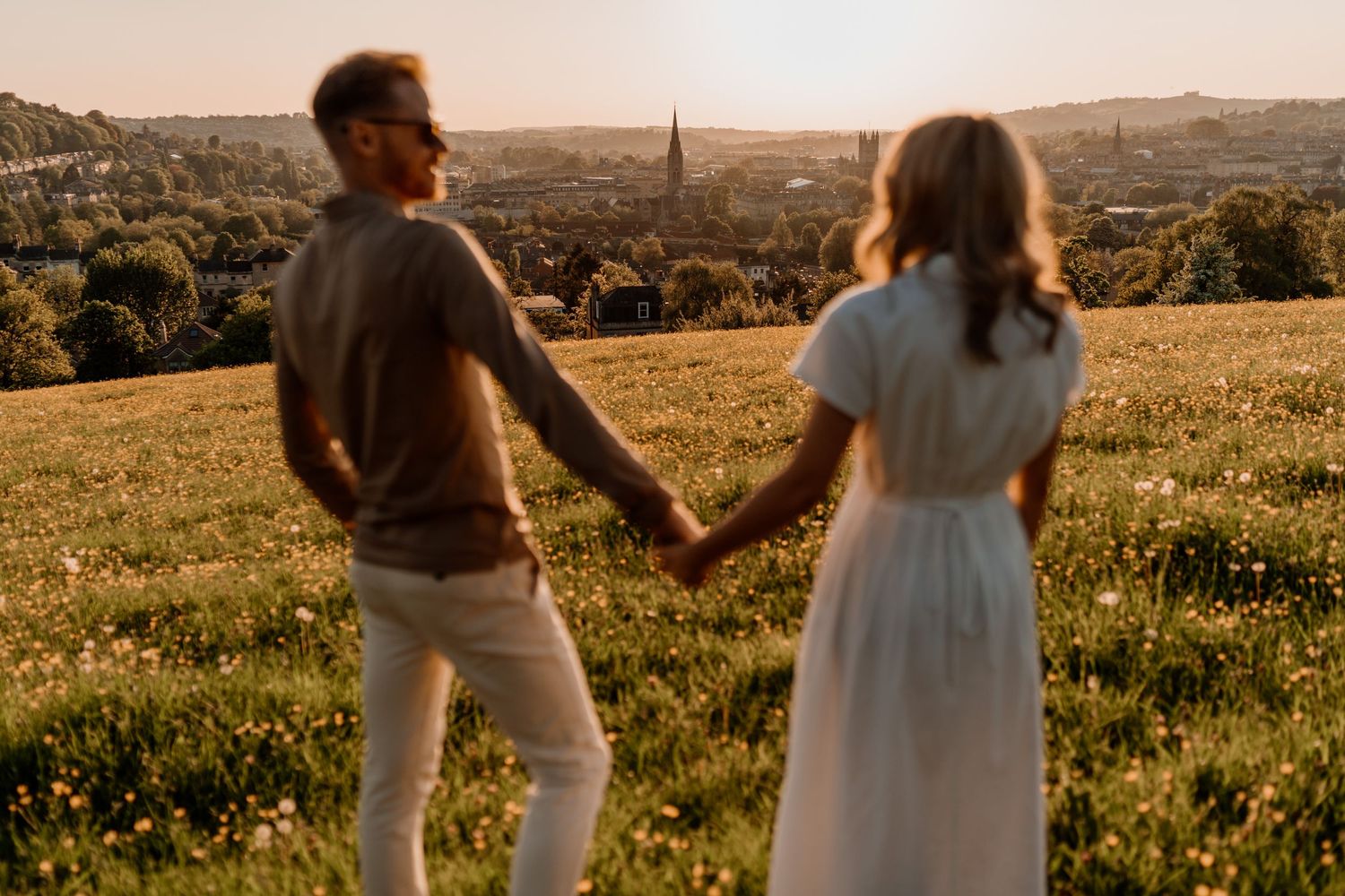 couple stood overlooking bath city skyline during wedding engagement photoshoot