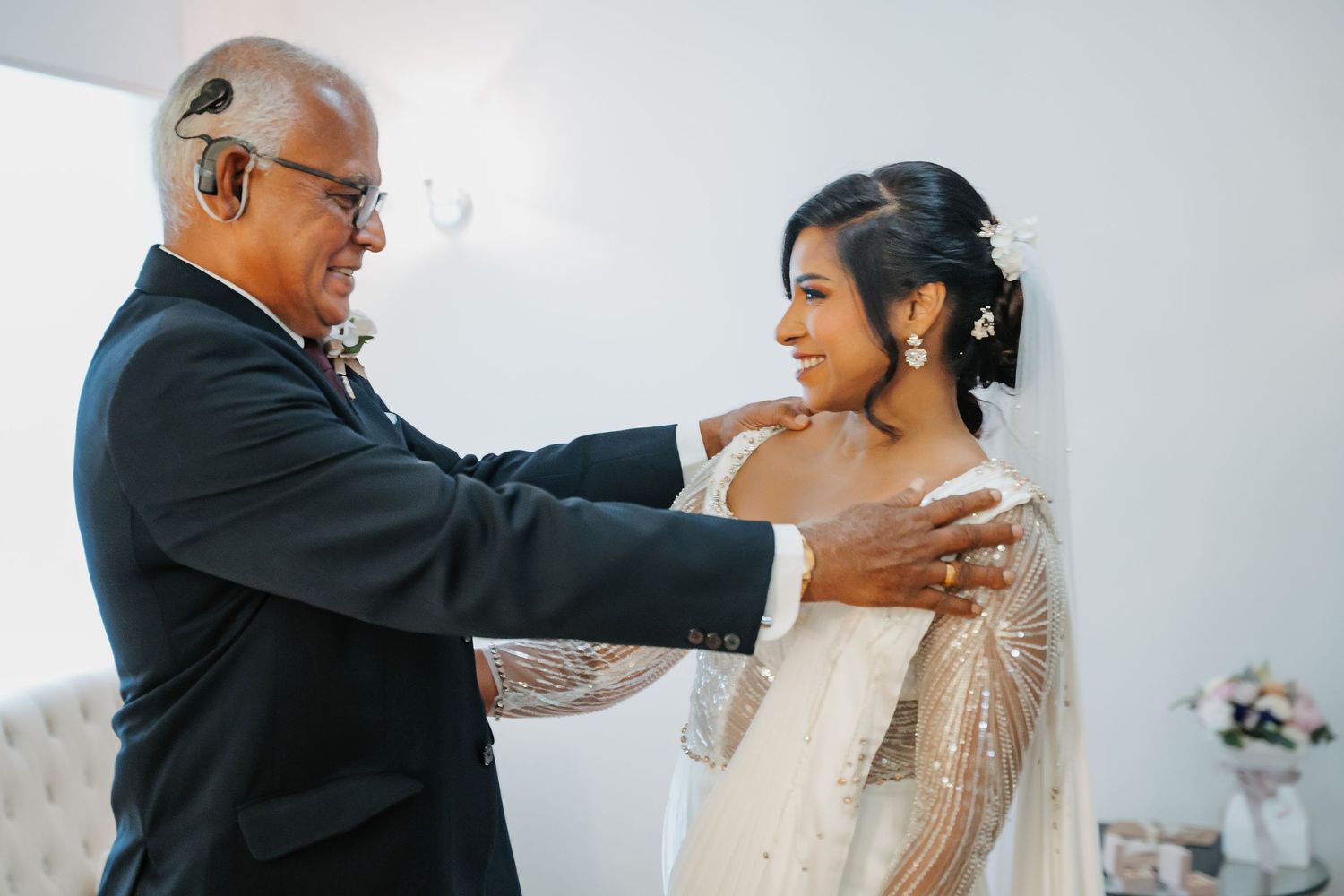 Father and bride share an emotional first look moment before her wedding ceremony.