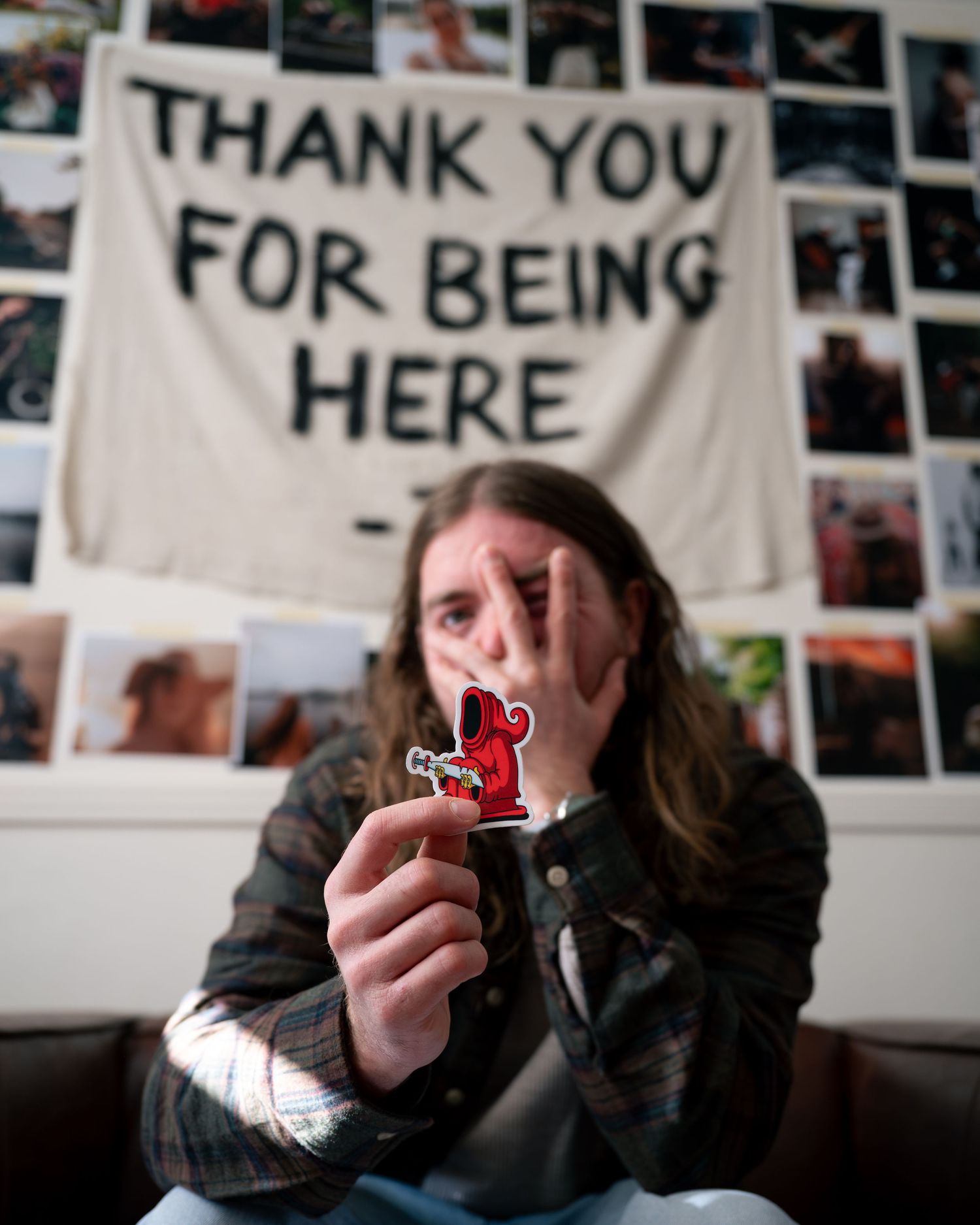 A sequence of four photos showing someone holding and examining a small object against a wall with photos and text.