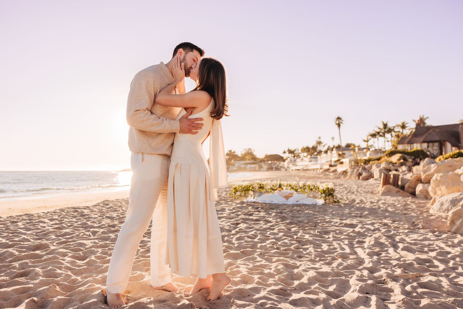 Man proposing to woman at Miramar Beach in Montecito and a photographer captures the surprise