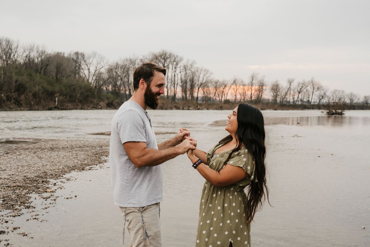 engaged couple plays in river at engagement photo session