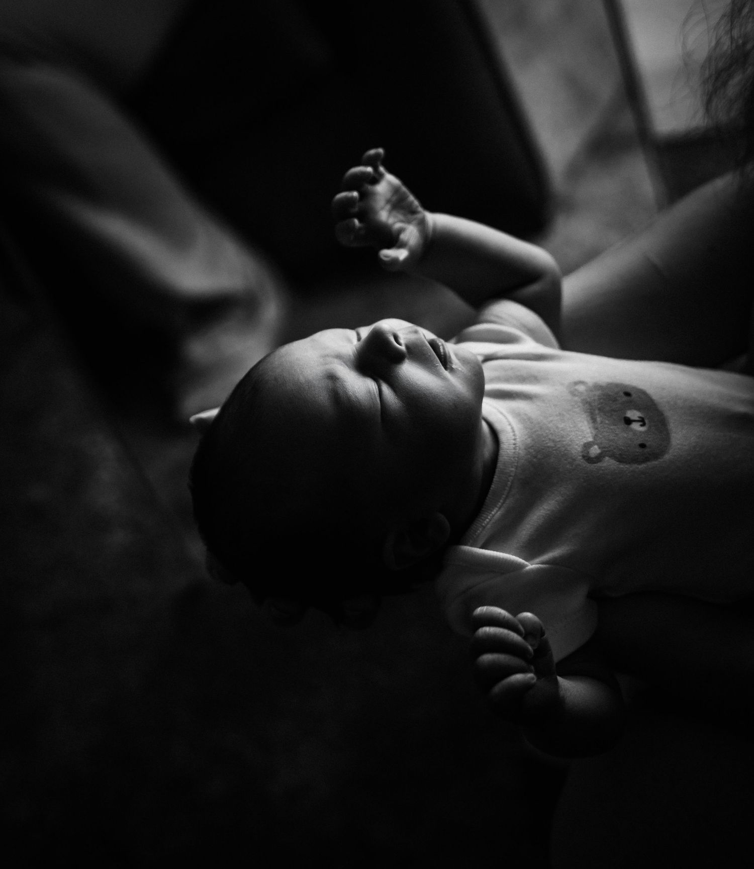 A series of black and white close-up photos showing hands and tattoos in dramatic lighting and composition.