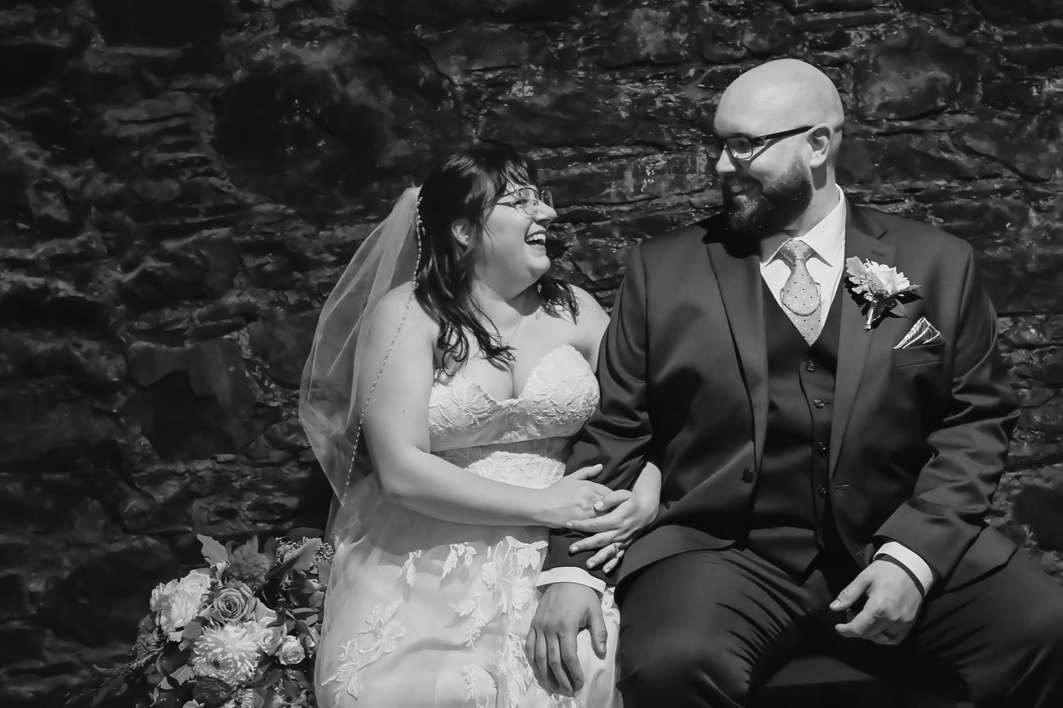 wedding couple kissing under reddish leaves of fall season at Bowring park, St. John's, Newfoundland.
