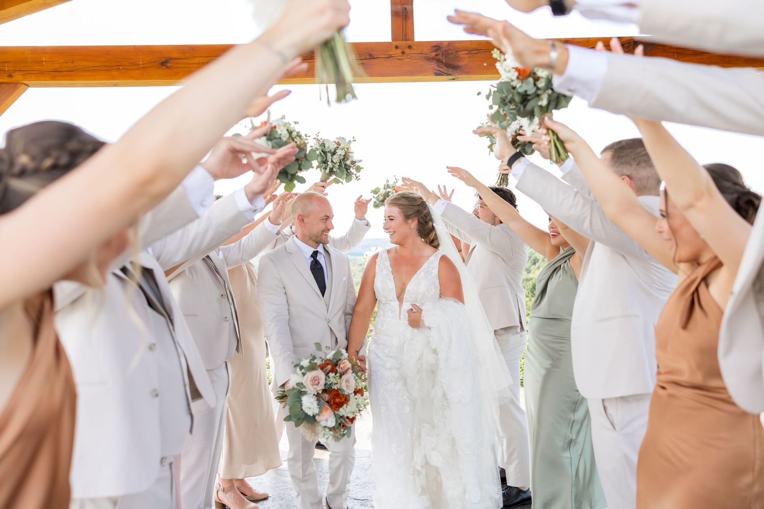 Wedding party celebrates with raised arms during outdoor ceremony at the roost wedding venue taken by Edward Jacobs photography