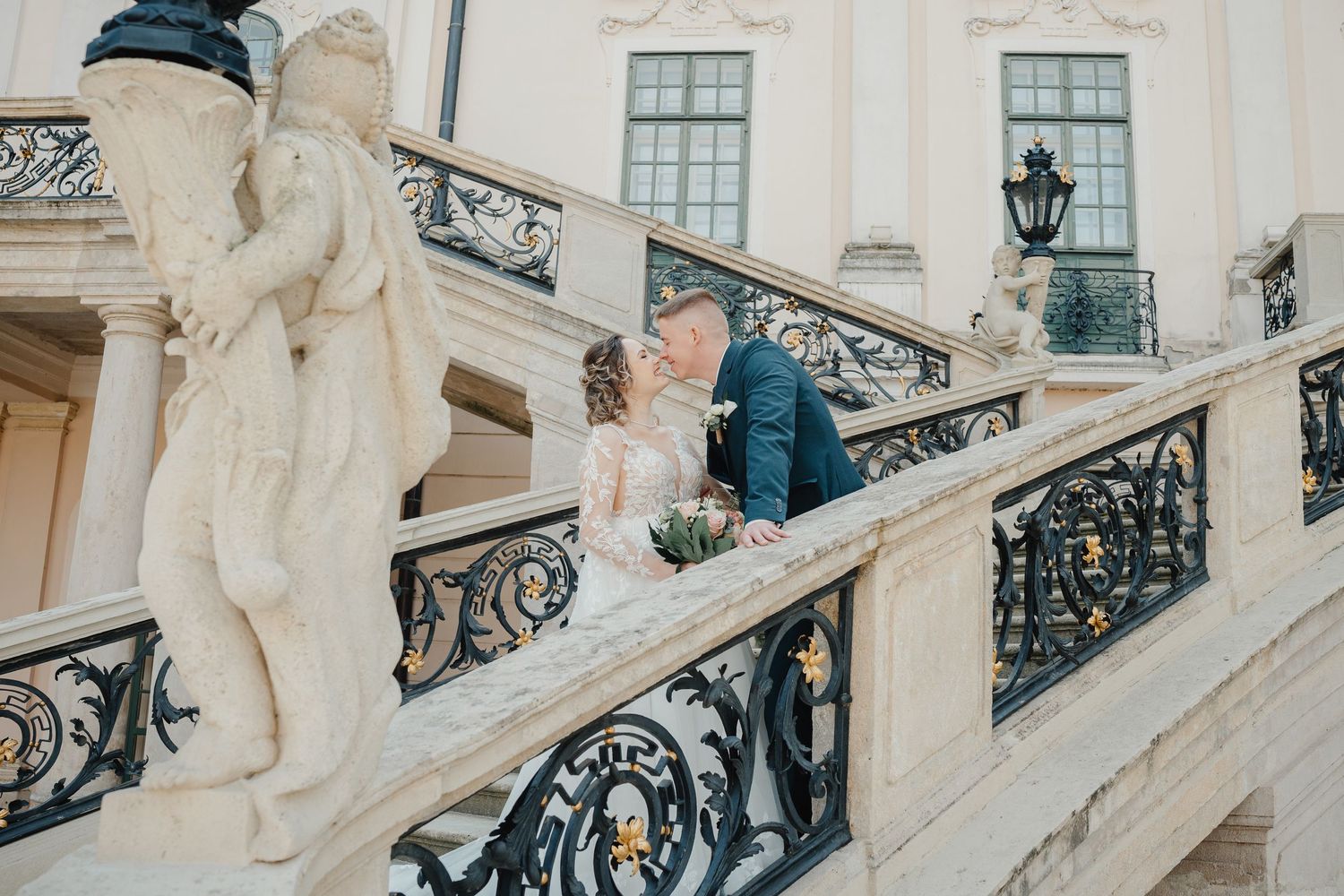 Grand white neoclassical mansion exterior with symmetrical dual staircases and arched entrance at Eszterháza Palace.