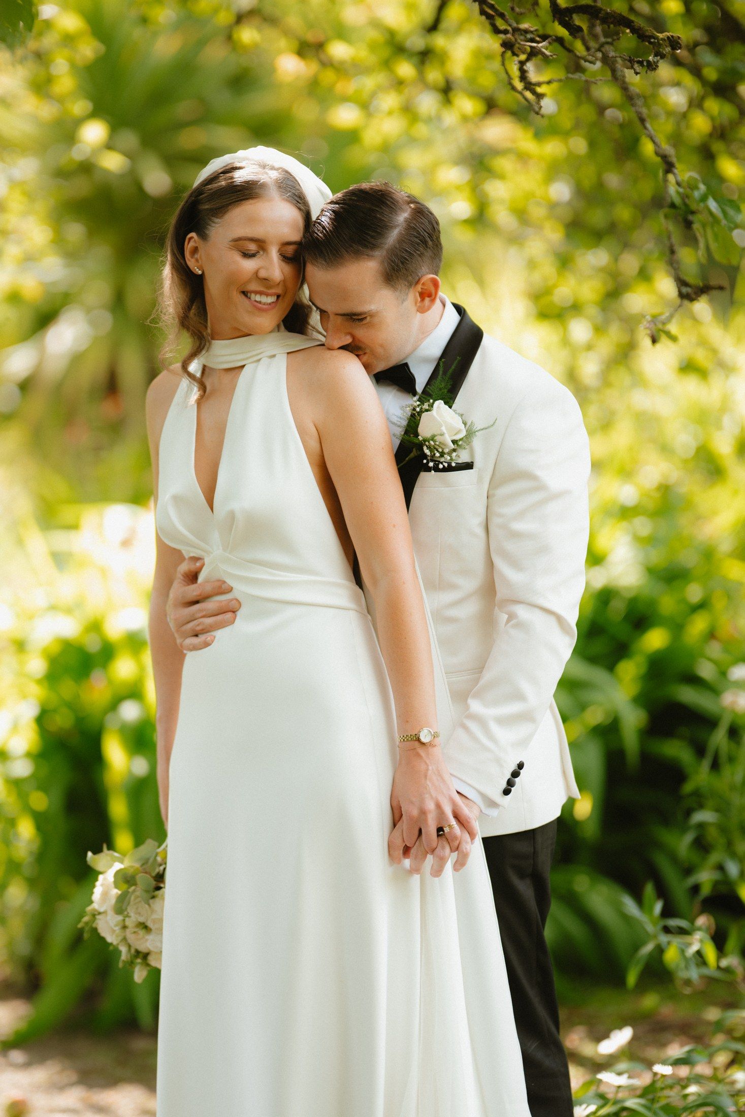 Róisín and Will together beneath the trees in the gardens at Ballymascanlon Hotel.