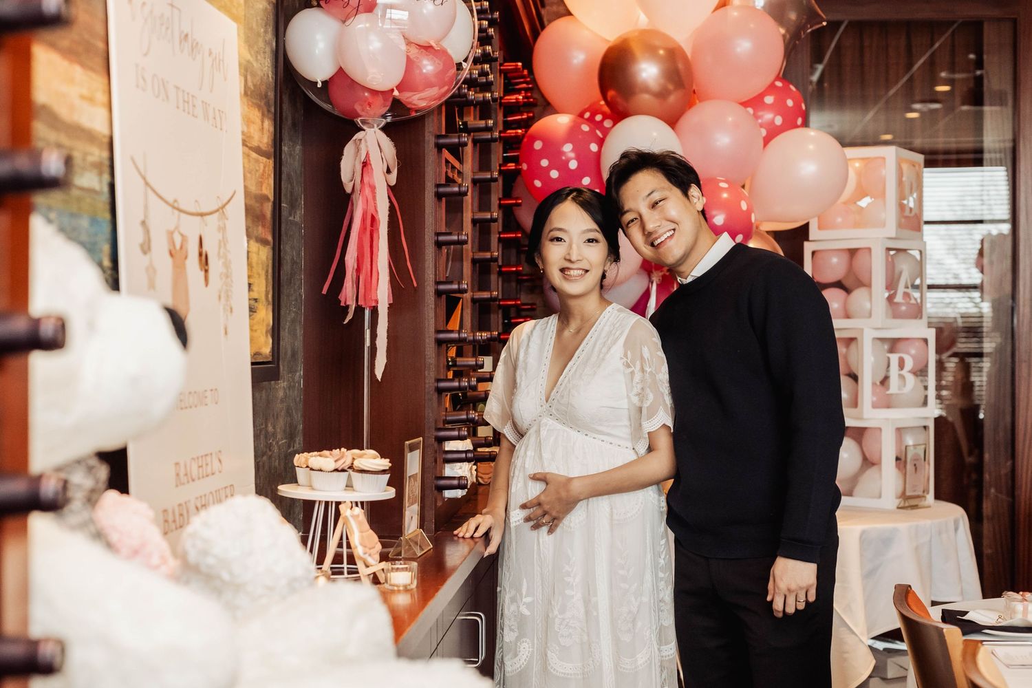 Celebration setup with pink balloon decorations and romantic ambiance.