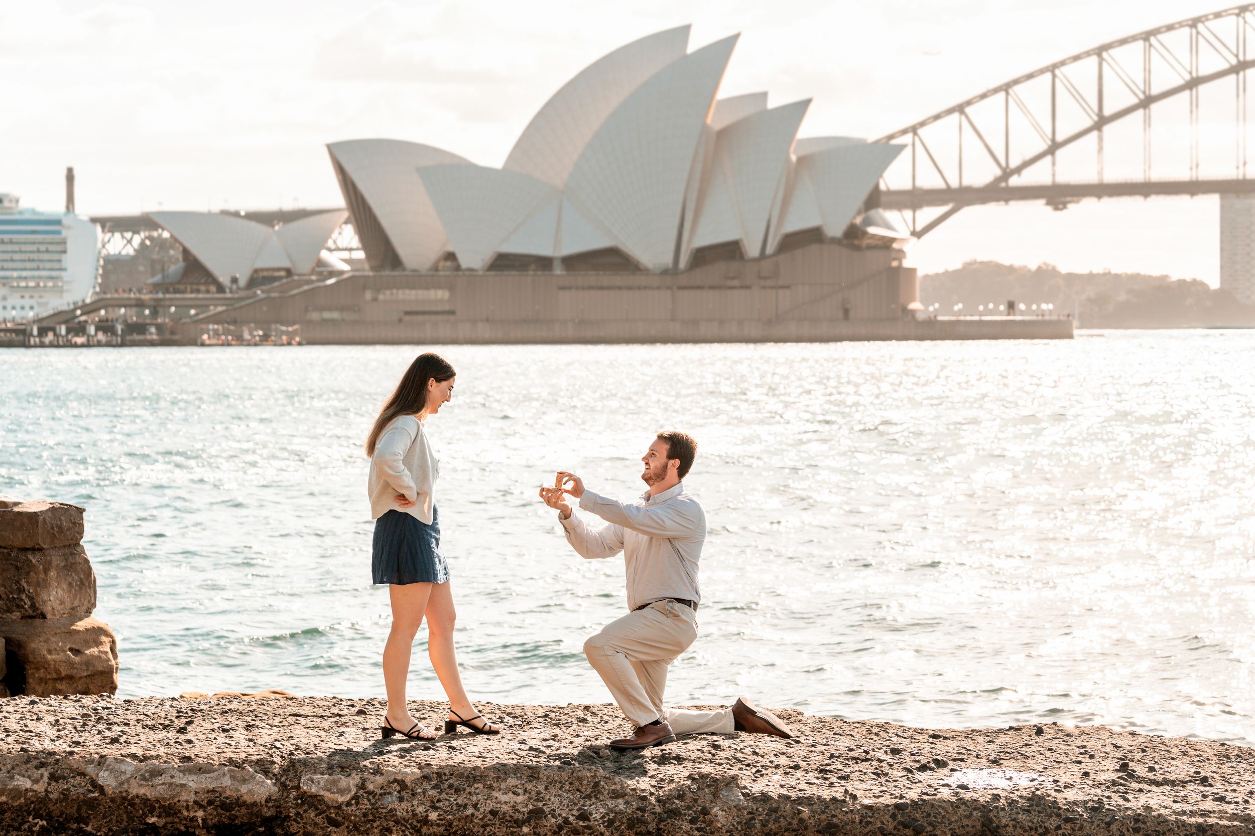 a surprise proposal photoshoot in the heart of Sydney. Man kneeling down and asks his girlfriend to merry him