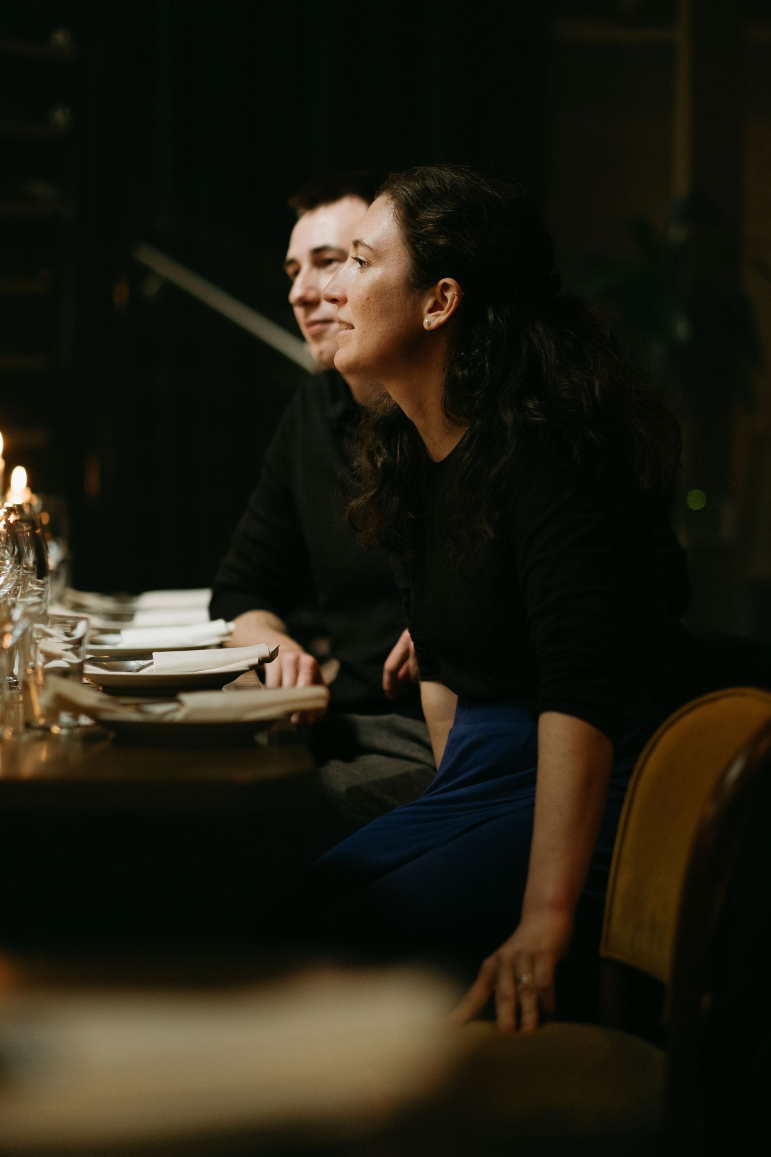 man and a woman sitting in a dark in restaurant TED in Stockholm while being captured by Stockholm event photographer