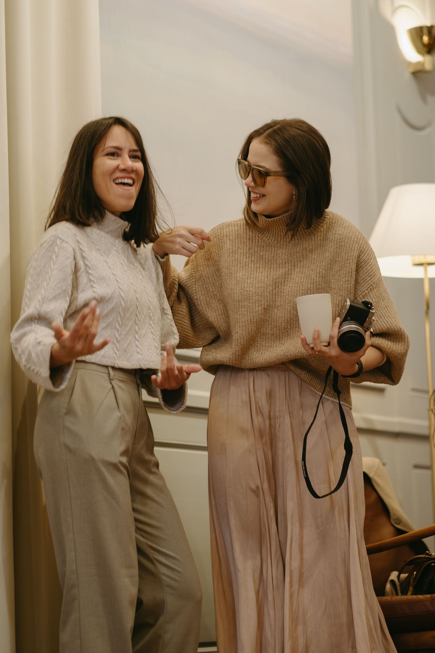 two women laughing while being captured by event photographer in Stockholm