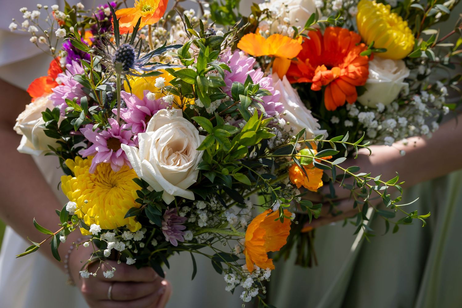 spring colored bridal bouquet orange, yellow, lavender, white, and green