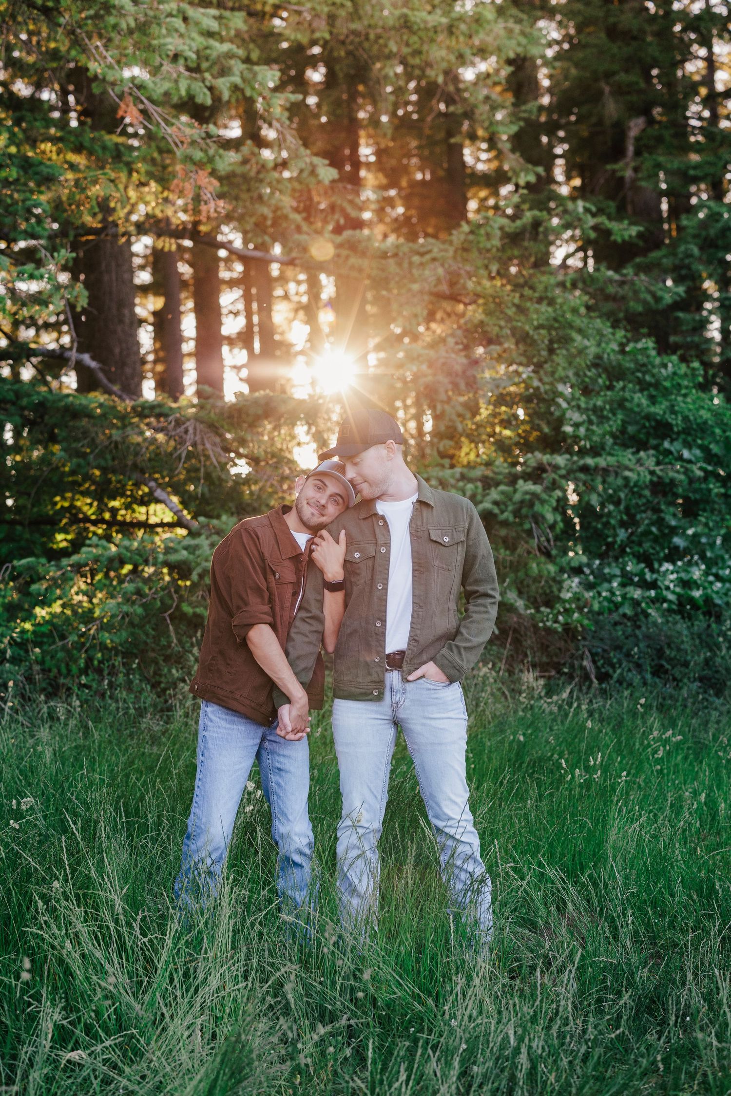 A romantic sunset moment in a forest meadow with golden sunbeams filtering through tall evergreen trees.