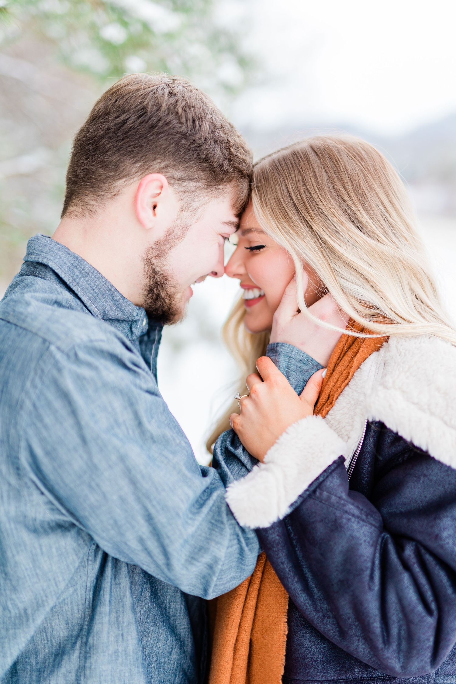A romantic moment between a couple sharing a close embrace in natural lighting.