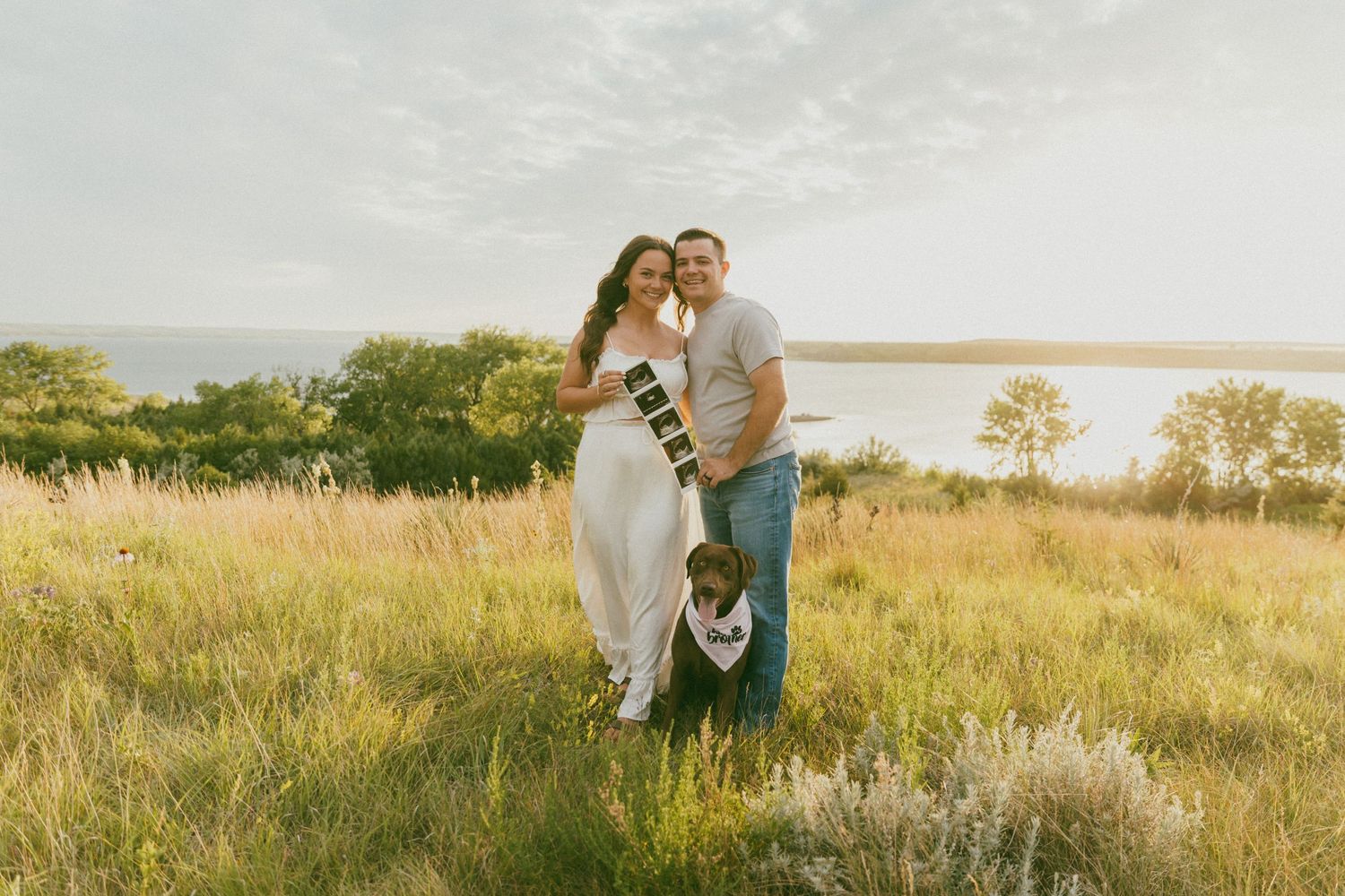 Romantic sunset photoshoot in a golden field with tall grass.