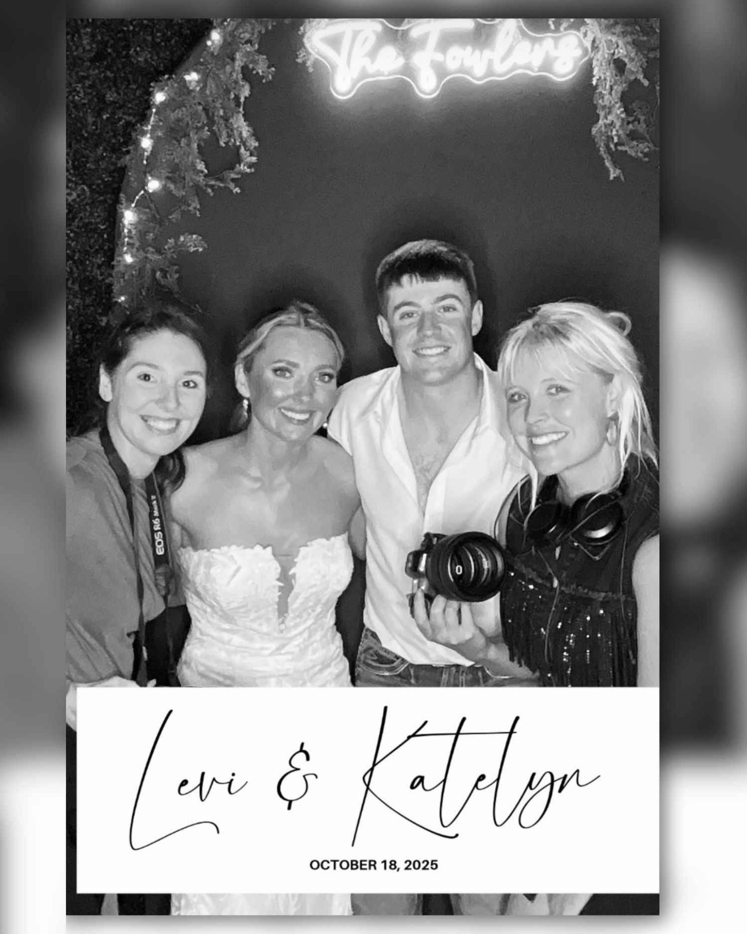 A black and white photo showing a group of people smiling and posing together at what appears to be a social gathering.