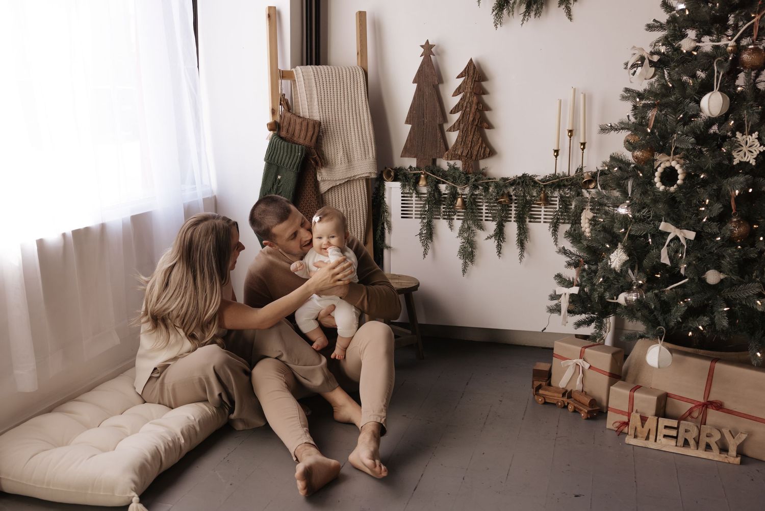 Cozy family Christmas photos with decorated tree and neutral decor.