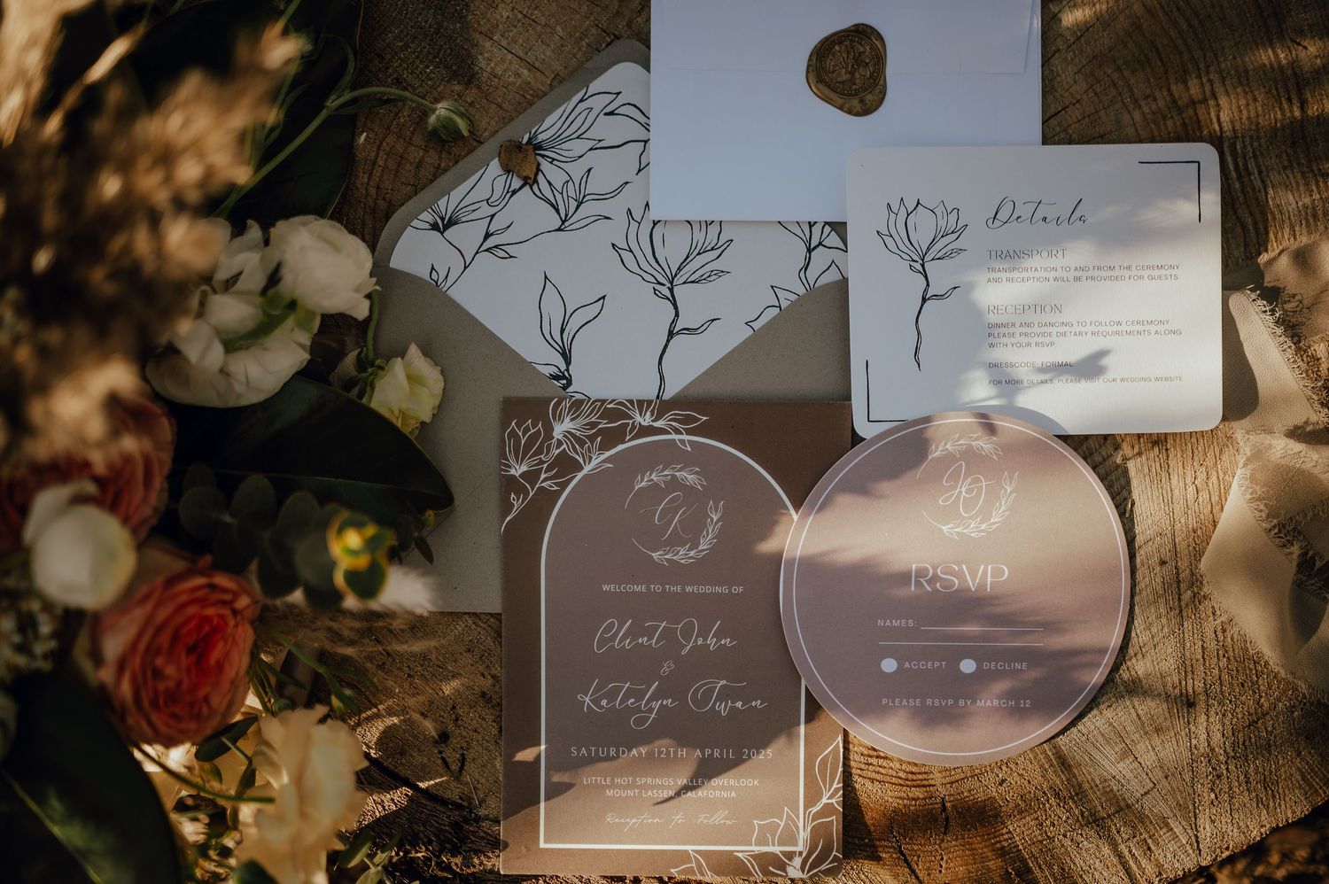 Clear acrylic wedding place cards with elegant calligraphy and botanical designs create a romantic tablescape setting.