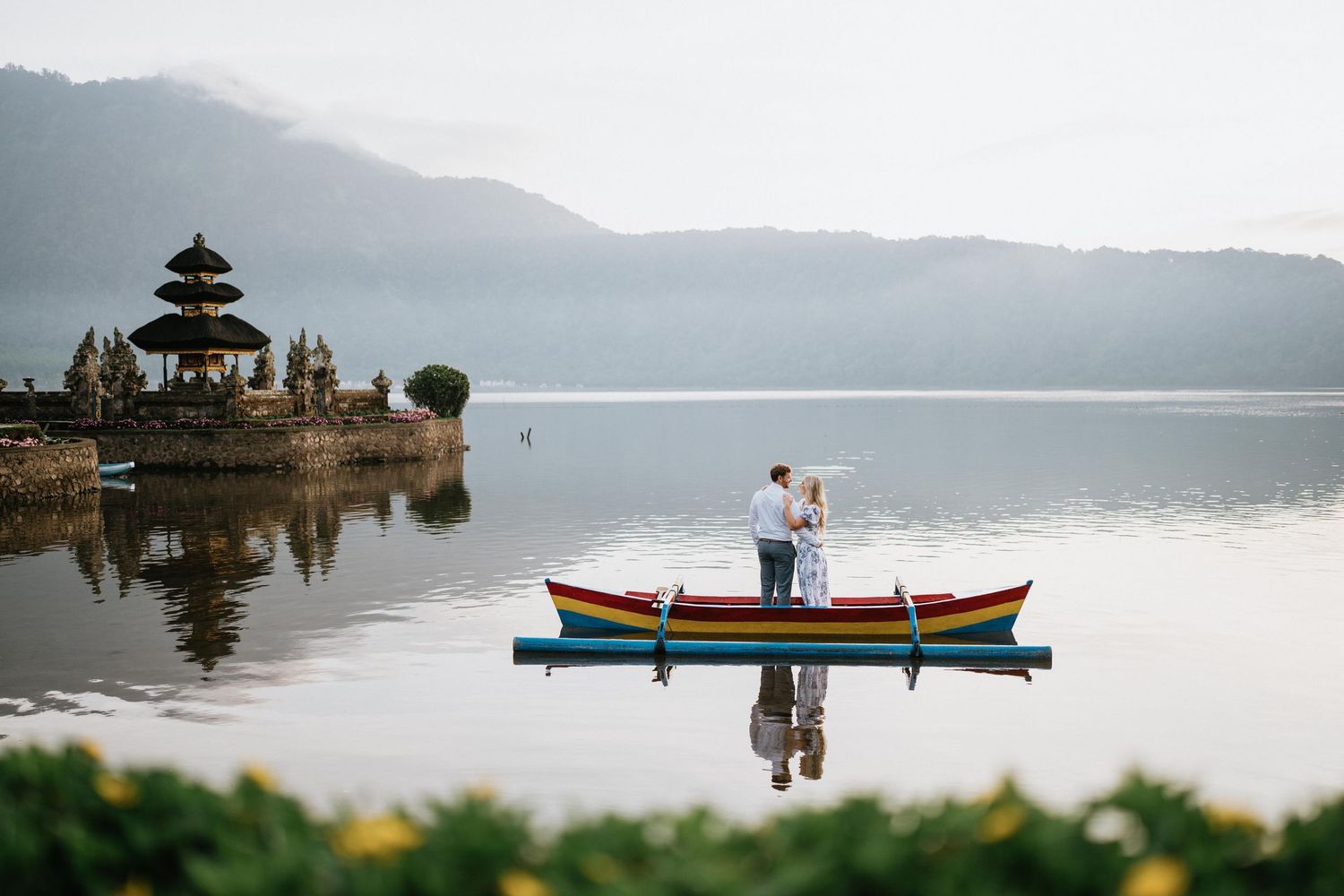 Scenic view of Ulun Danu Beratan Temple with boats on lake in Bali.