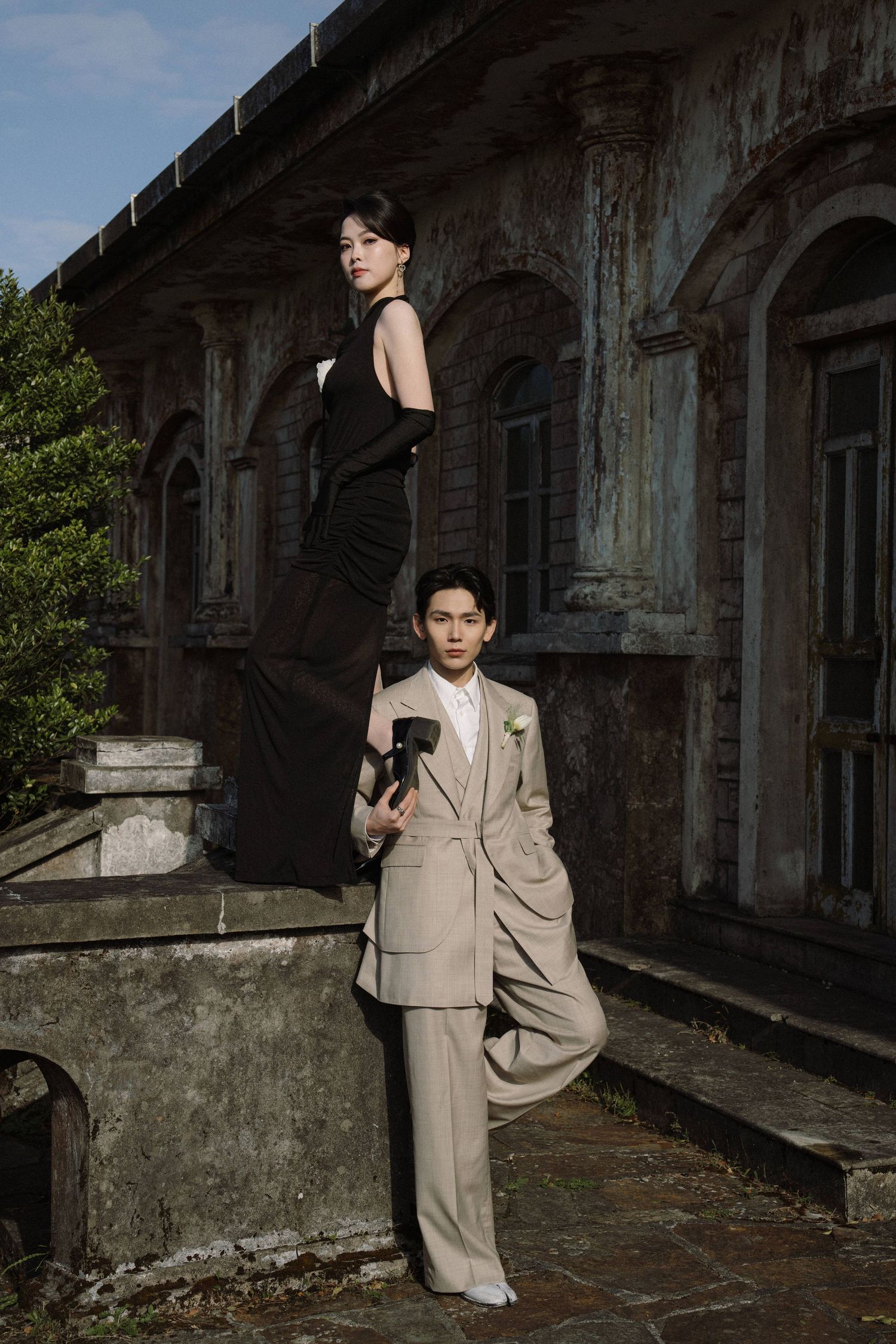 Fashion photography at abandoned architecture location featuring formal attire.