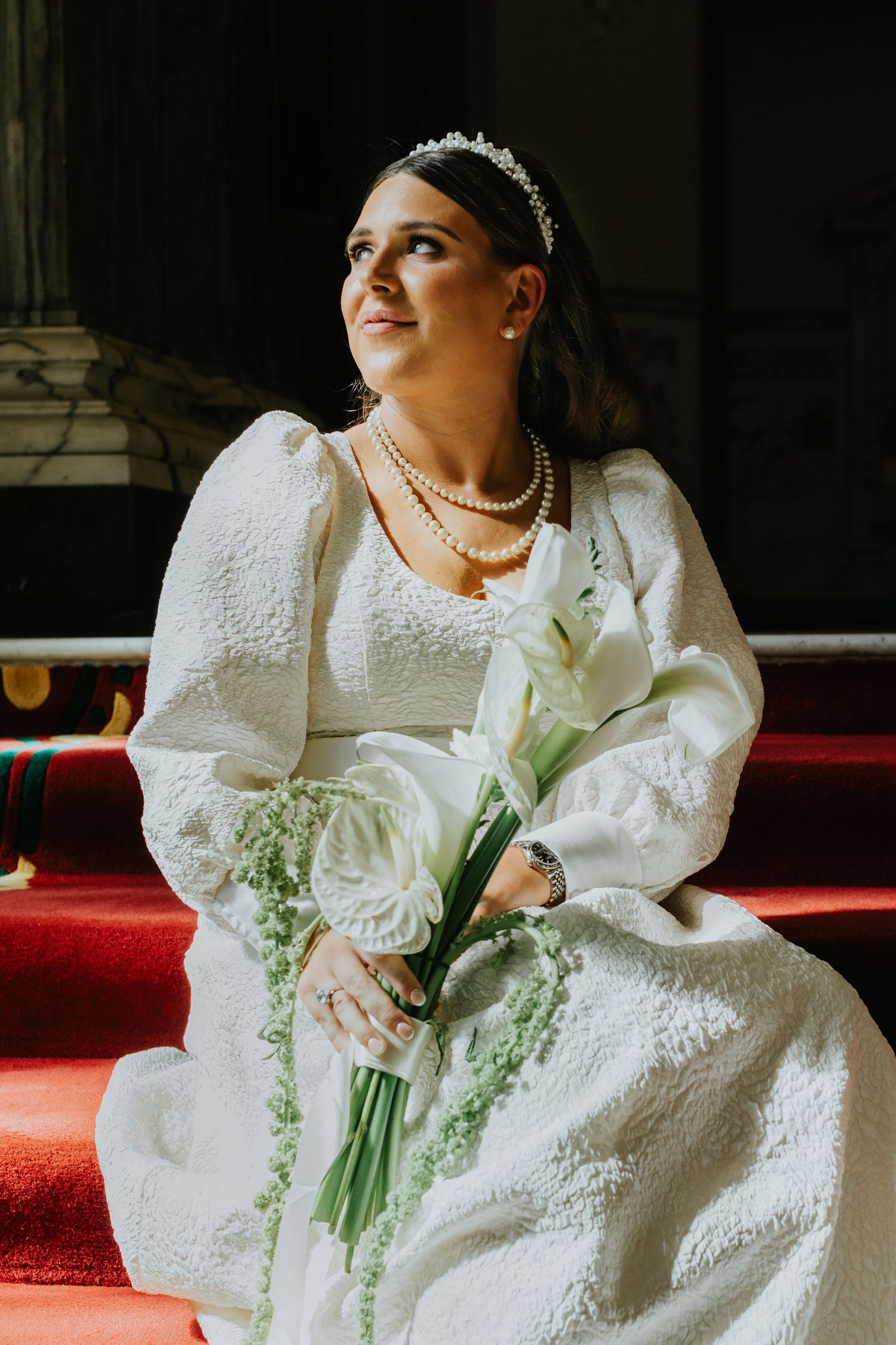 Bride sitting on the stairs at Belfast City Hall