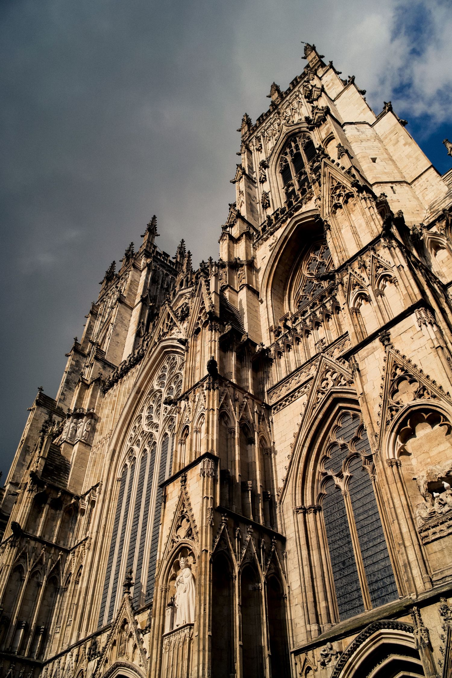 Gothic cathedral towers reaching skyward with intricate stone carvings and arched windows.
