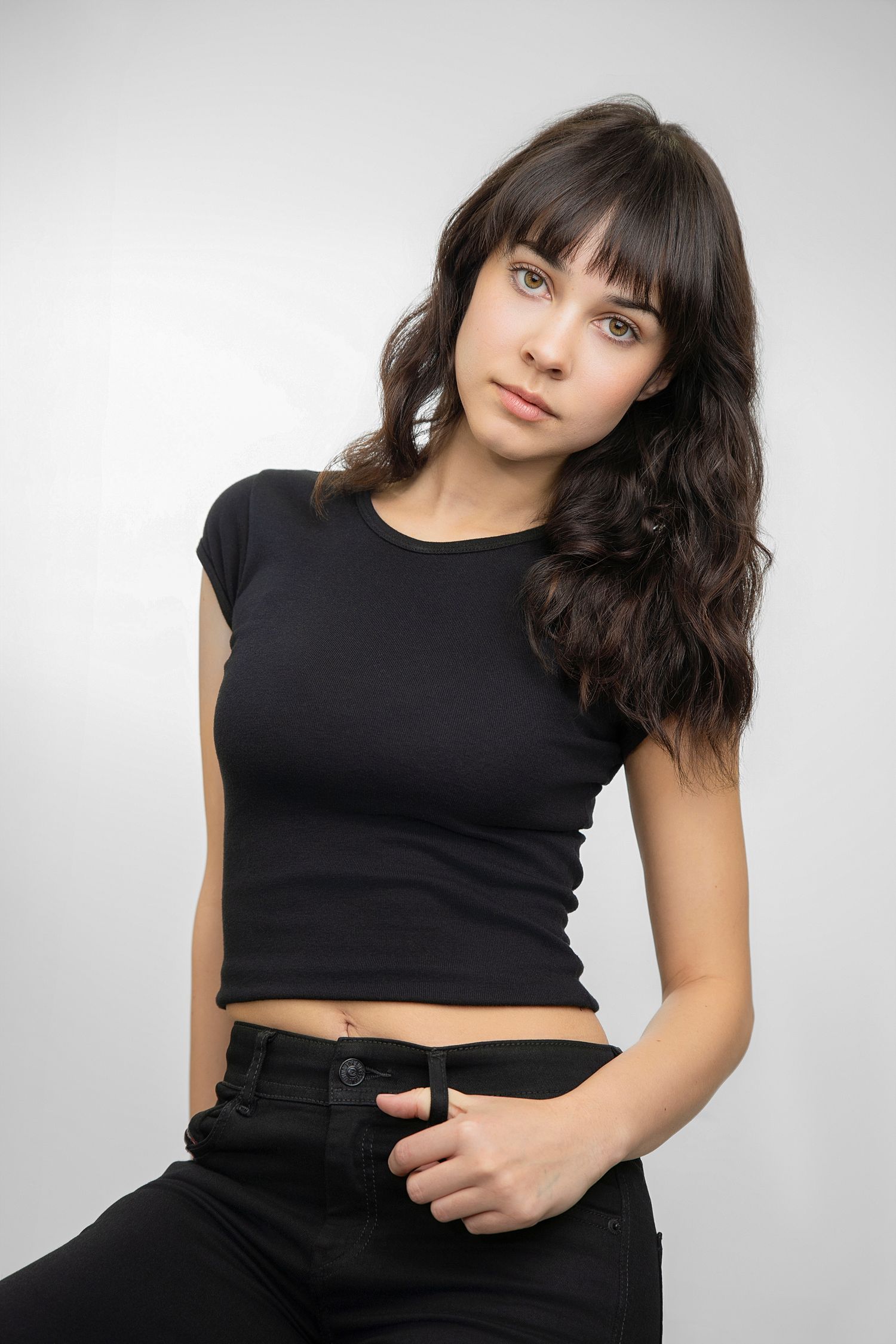 A person in a gray tank top poses expressively against a bright orange background in a photo series.