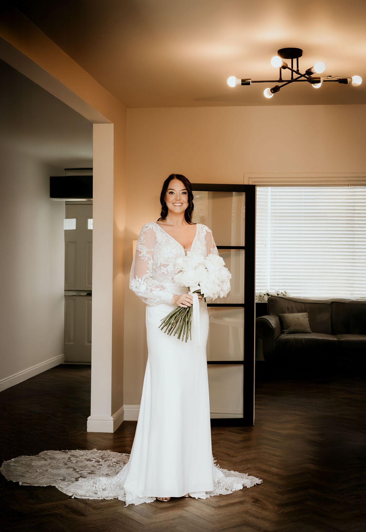 Elegant wedding photo on grand marble staircase with ornate baroque details and decorative trim in historic venue.