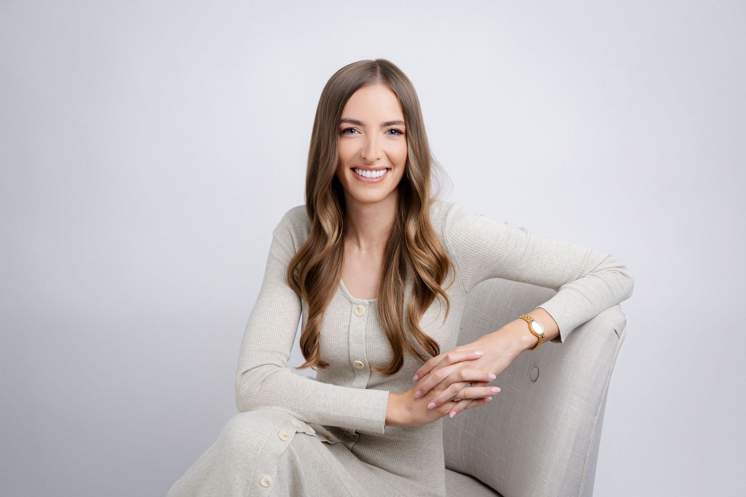 A series of professional lifestyle photos showing someone smiling and holding a phone while sitting on a gray couch.