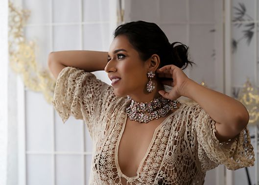 A woman in a sequined gold dress poses elegantly in several artistic portrait shots near a window.