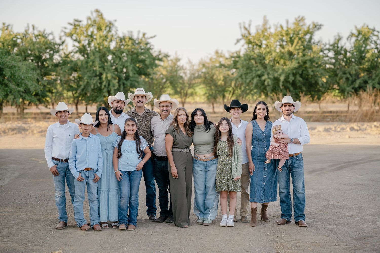 A series of coordinated family portraits showing multiple groups in casual attire standing outdoors in natural lighting.