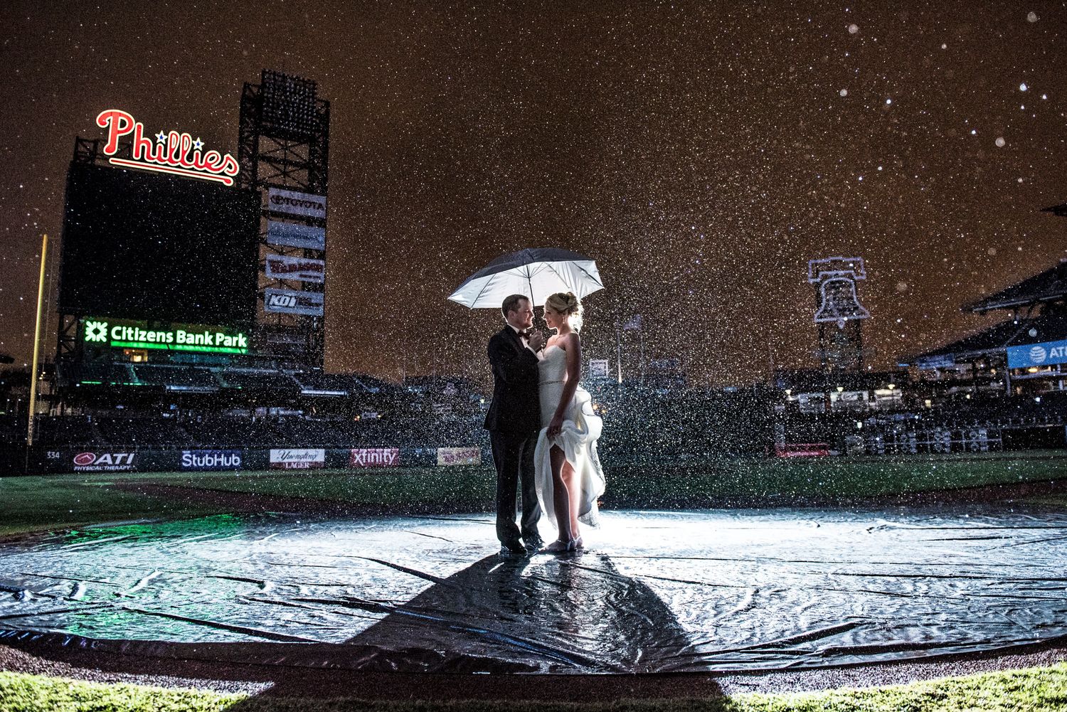 A dramatic wedding photo at night at Citizens Bank Park in Philadelphia