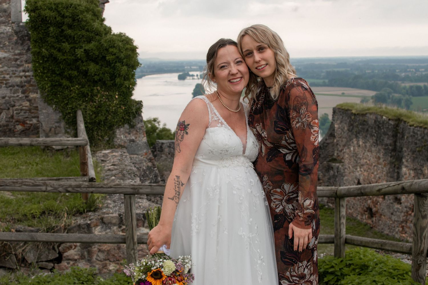 Two newlyweds display their matching silver wedding rings on their ring fingers in a close-up photo.