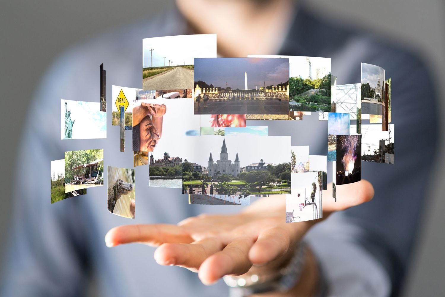 A guy holding images in his hand