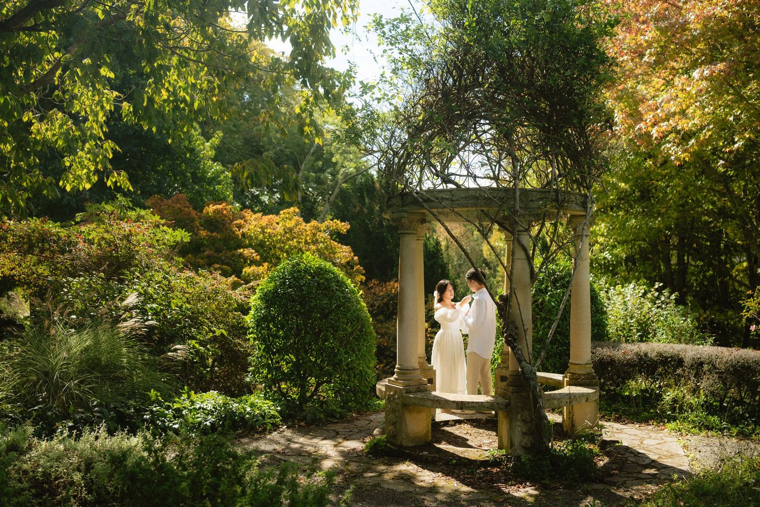 Delicate white veil flows in the breeze during an outdoor wedding ceremony.