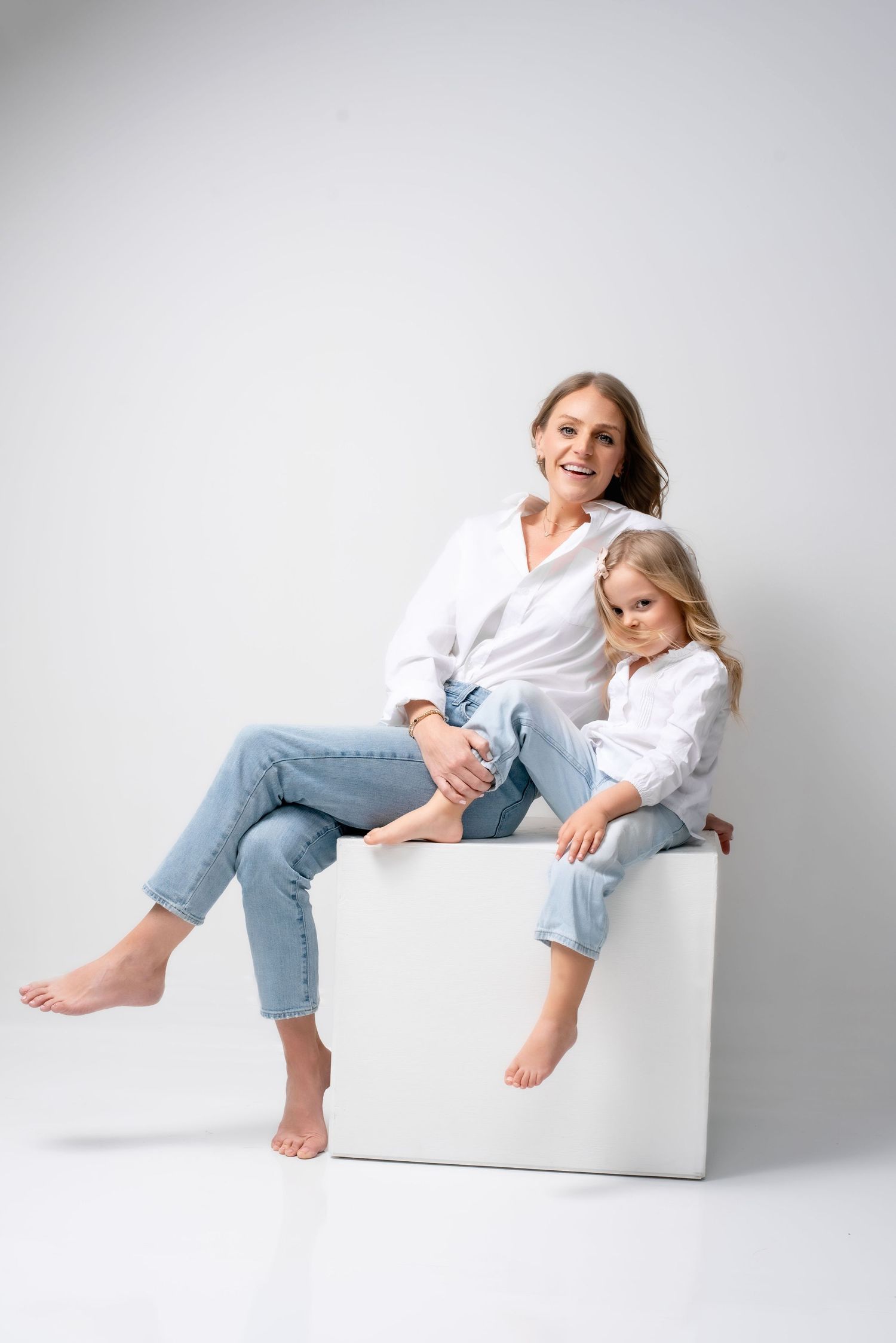 Mother and daughter studio portrait in Nashville with professional lighting, clean minimal background and timeless family photography style.