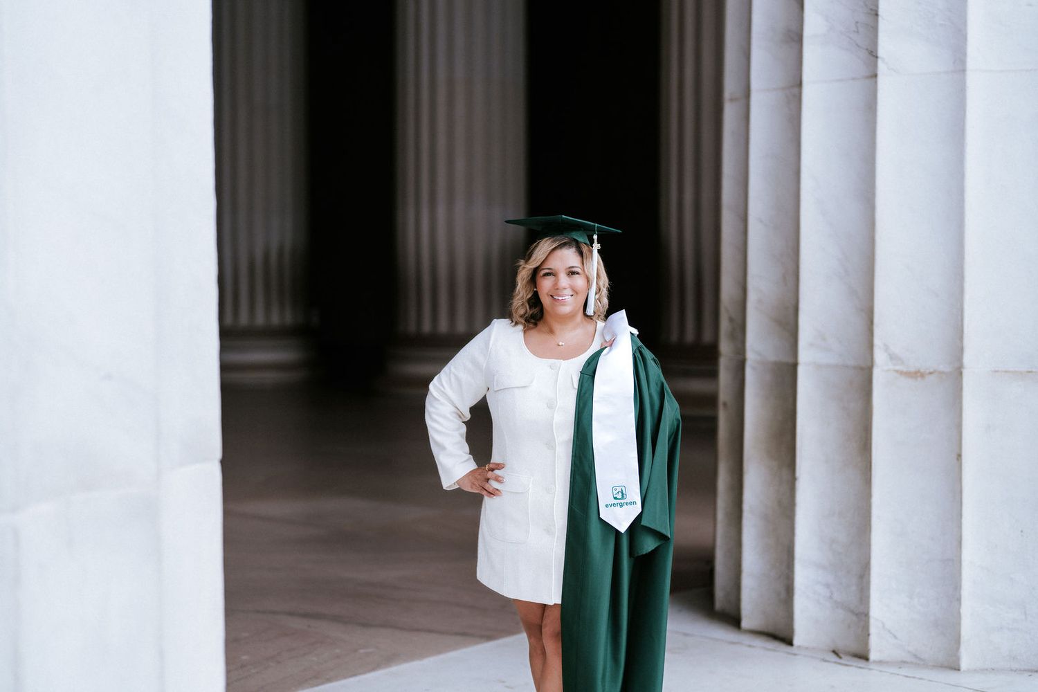 College graduate in cap and gown photographed at the Lincoln Memorial in Washington DC